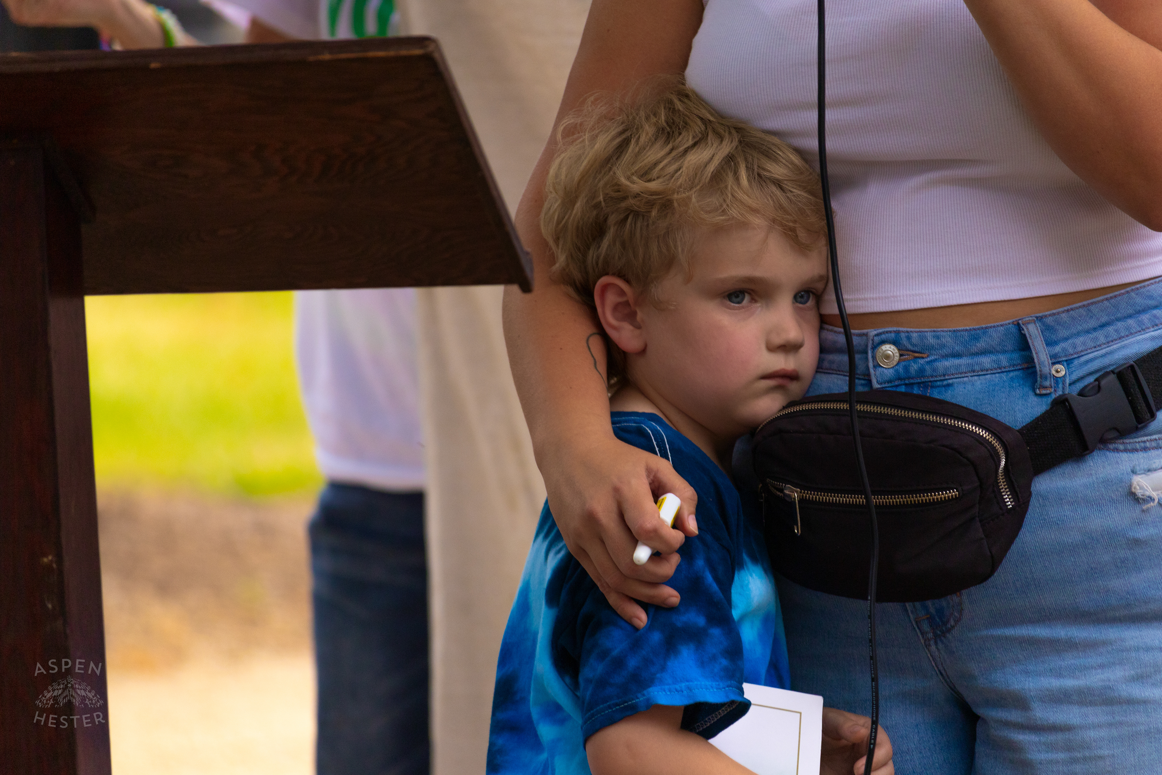 Samantha Elkins Son Hugs Her Leg While She Demonstrates How to Use Narcan at The 3rd Annual Vocal KY International Overdose Awareness Day Rally and March. August 31st, 2024/Aspen Hester