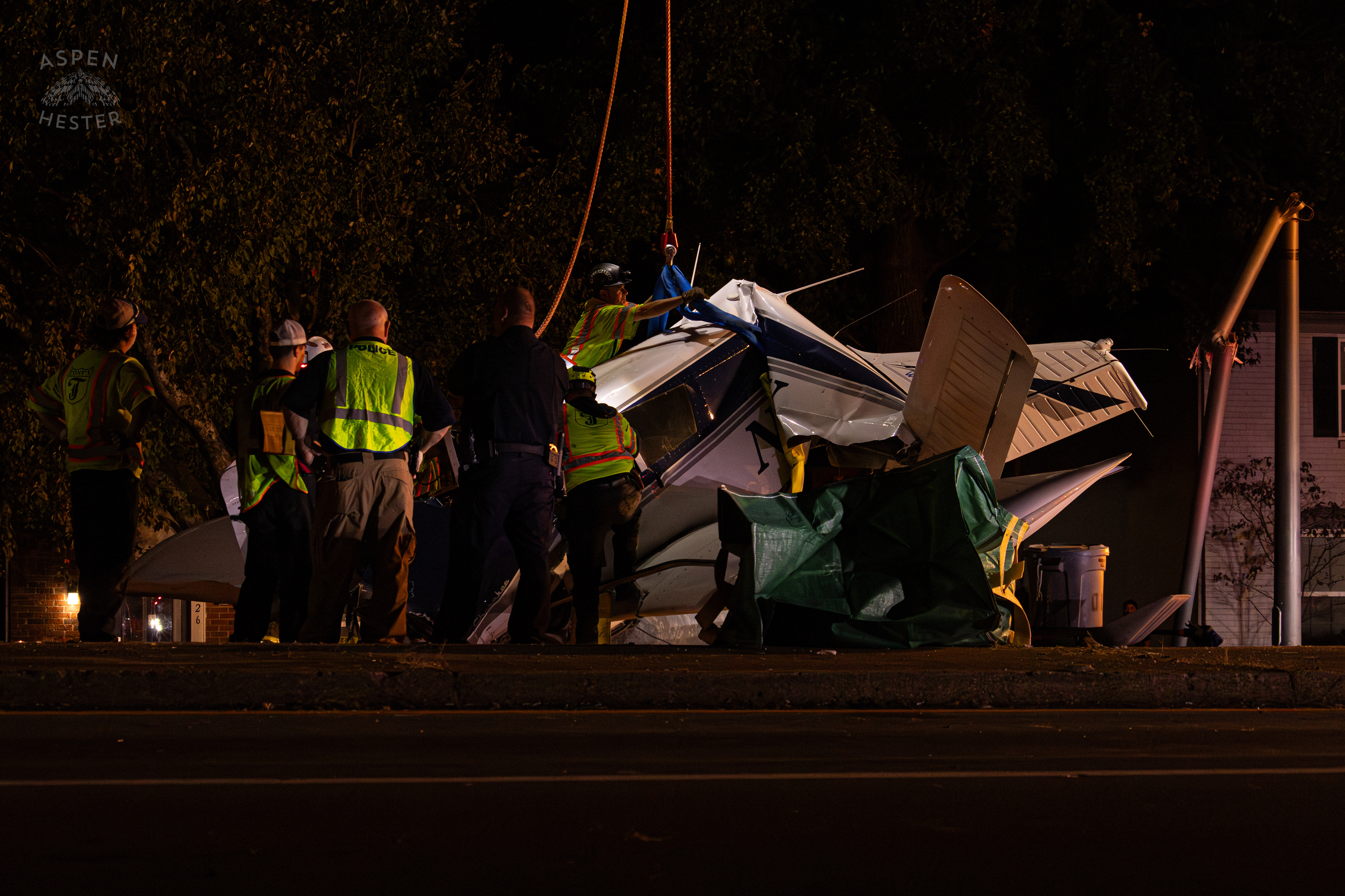 Tony’s Wreckers Crew Working to Remove The Piper Cherokee Plane from the Road after it Crash Landed, Taking Out Utility Poles, and Hitting A Car on Breckenridge Lane and Kresge Way. October 11th, 2024/Aspen Hester 