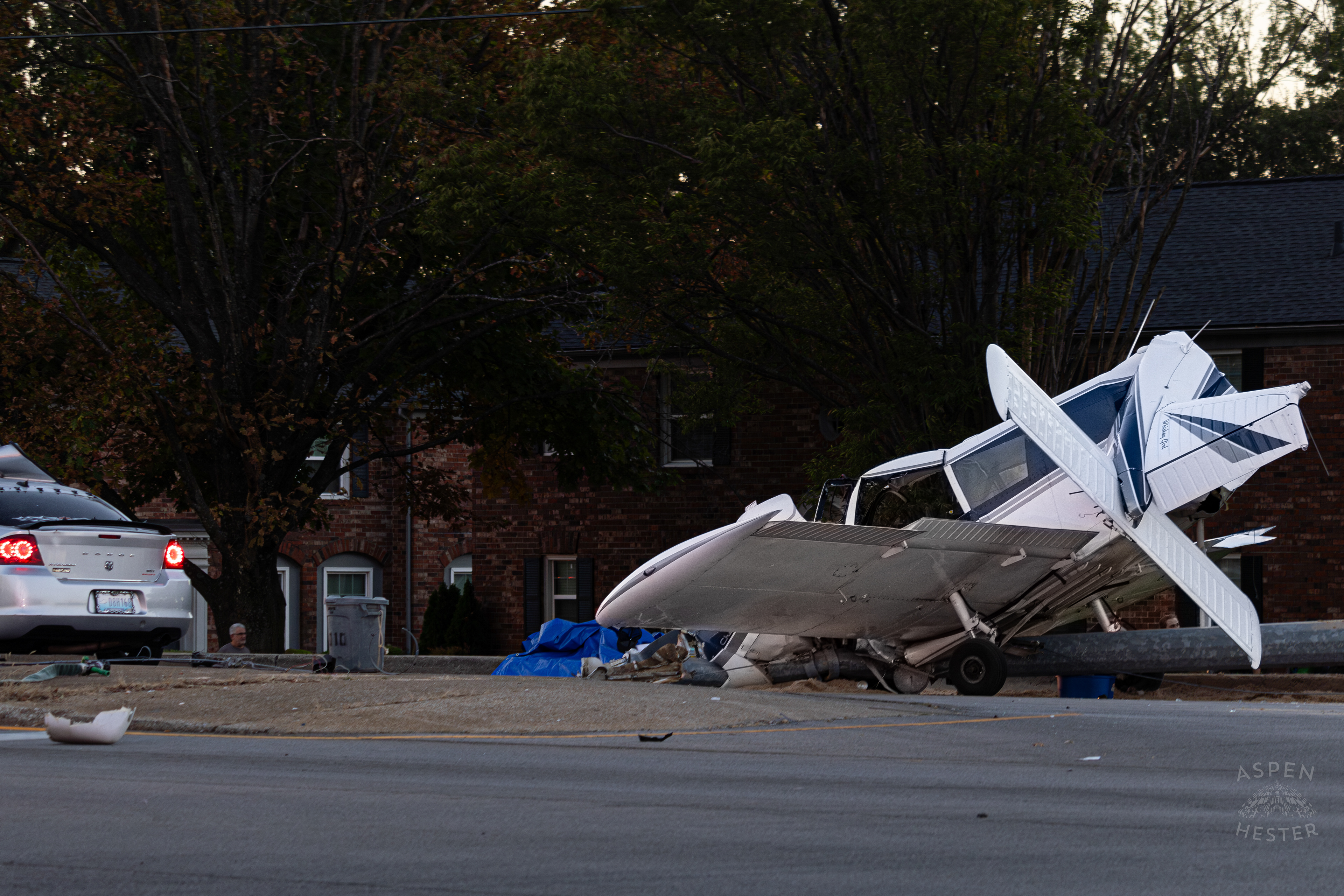 The Mangled Dodge Charger and Crumpled Piper Cherokee Plane after it Crash Landed, Taking Out Utility Poles, and Hitting This Car on Breckenridge Lane and Kresge Way. October 11th, 2024/Aspen Hester 