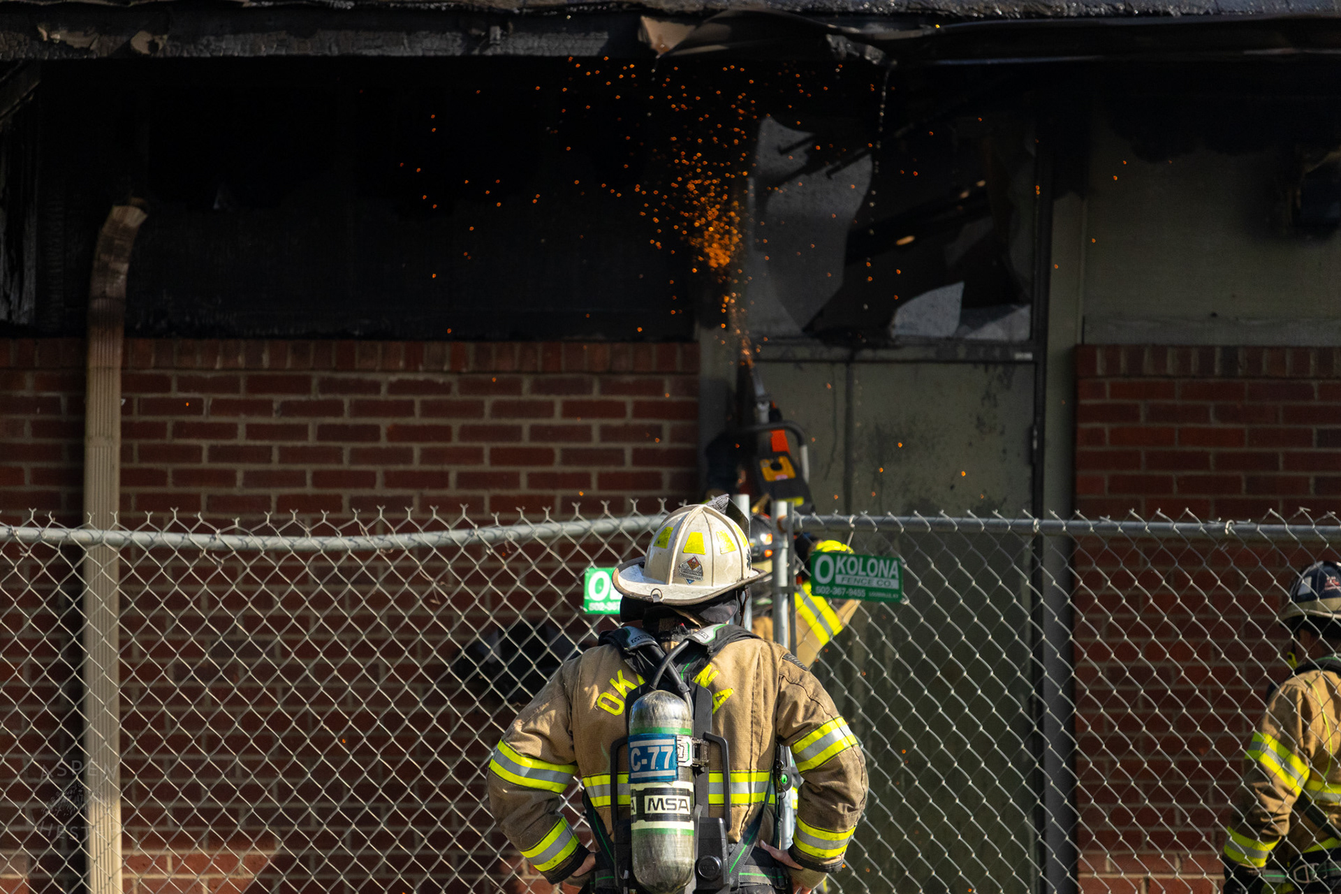 Firefighter Sawing into A Metal Door at The Old Library on Preston Highway. May 31st, 2024/Aspen Hester