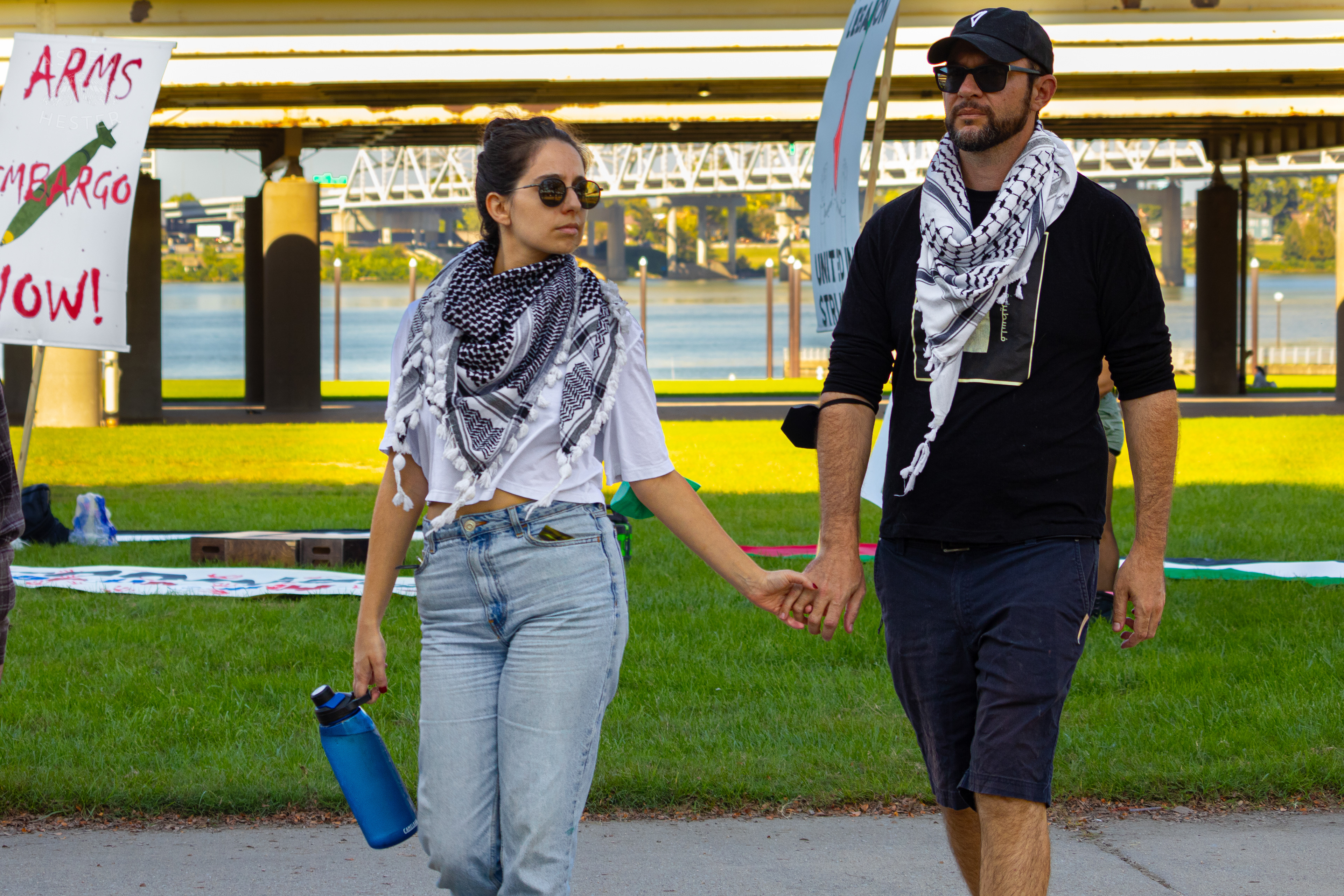 A Couple Walks Hand and Hand into Lousiville’s One Year of Gaza Genocide Rally. October 5th, 2024/Aspen Hester 