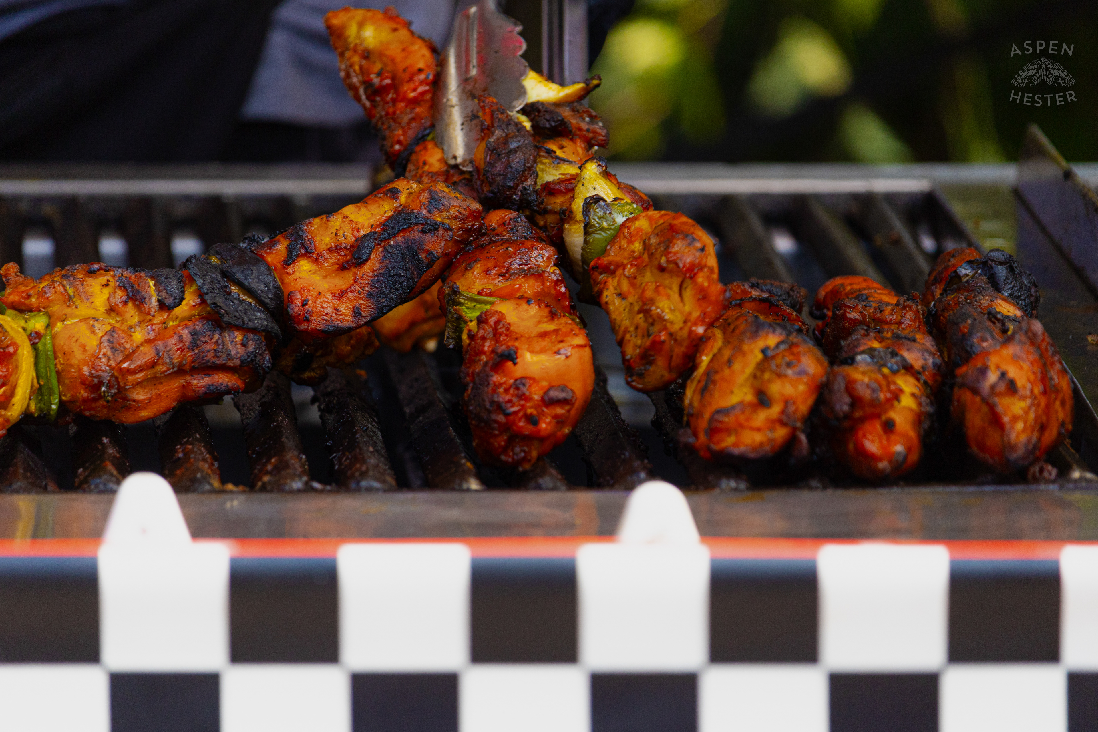 Chef at Enrique's Place Latin Grill Preparing Kabobs for The Opening Day of The 22nd Annual WorldFest. August 30th, 2024. Aspen Hester