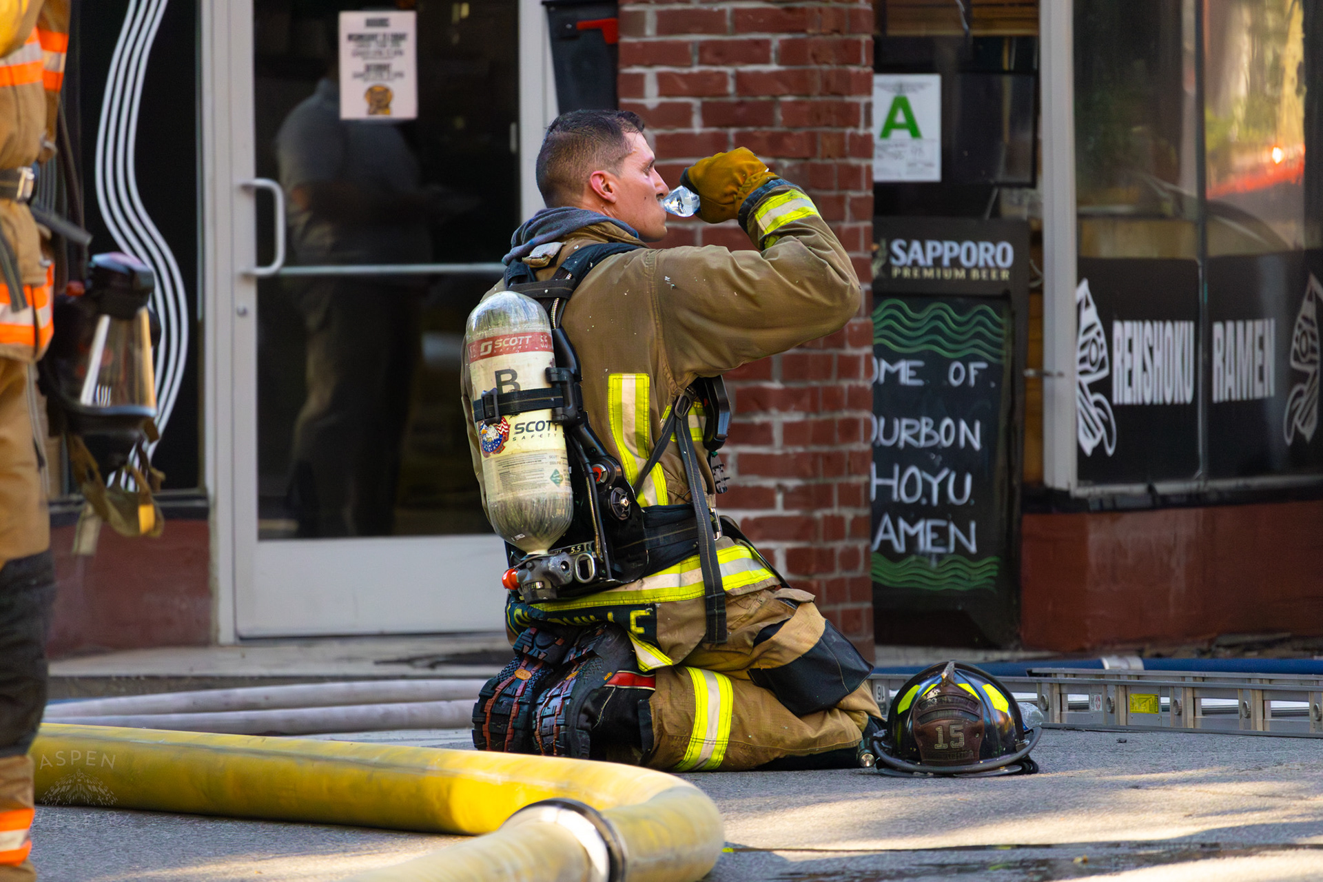 Louisville Firefighter Rests After Battling Flames on The Corner of 2nd and Oak Street. June 7th, 2024/Aspen Hester
