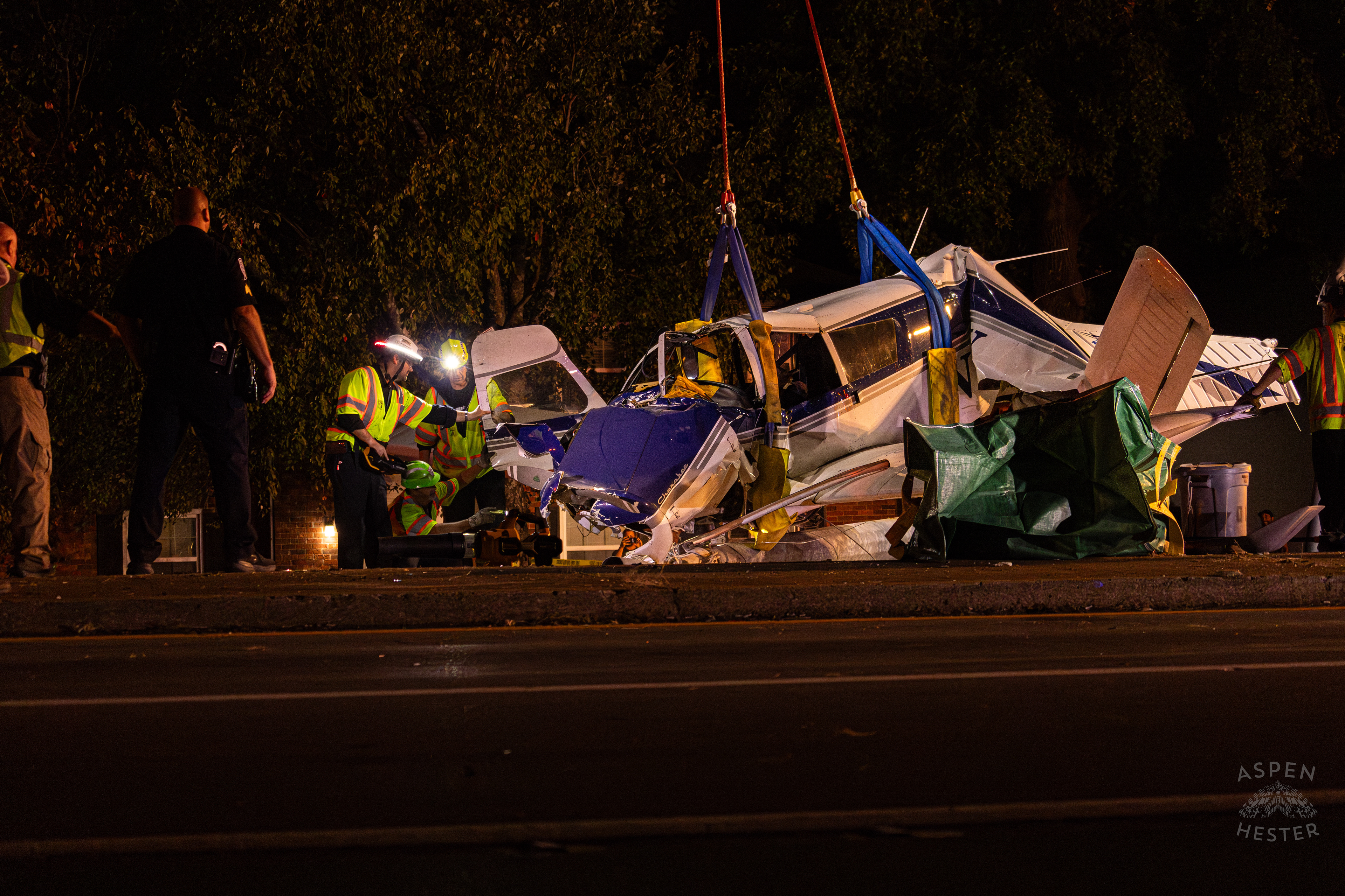 Tony’s Wreckers Crew Working to Remove The Piper Cherokee Plane from the Road after it Crash Landed, Taking Out Utility Poles, and Hitting A Car on Breckenridge Lane and Kresge Way. October 11th, 2024/Aspen Hester 