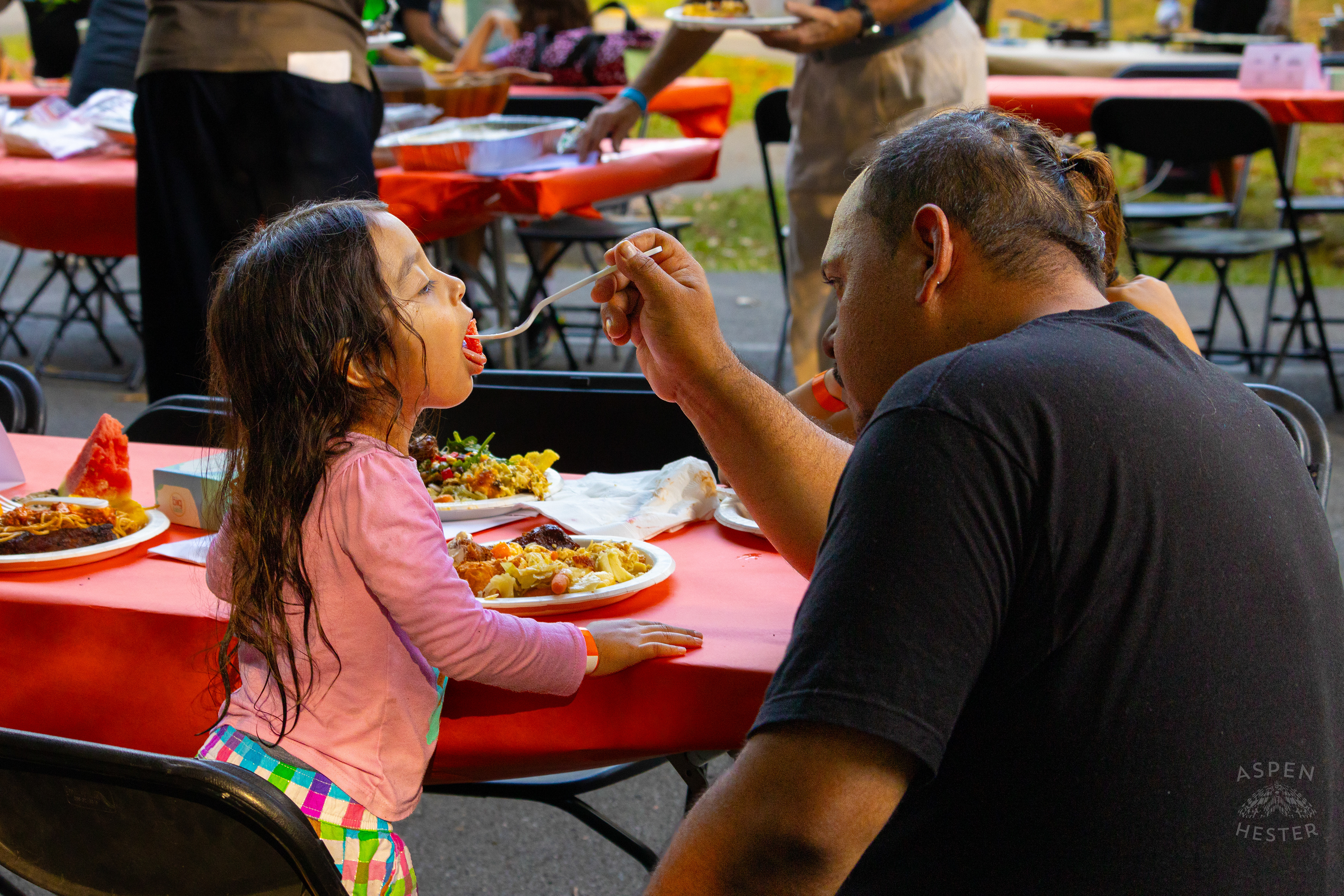 A Father Feeds His Young Daughter from The Big Table at Iroquois Park. September 15th, 2024/Aspen Hester