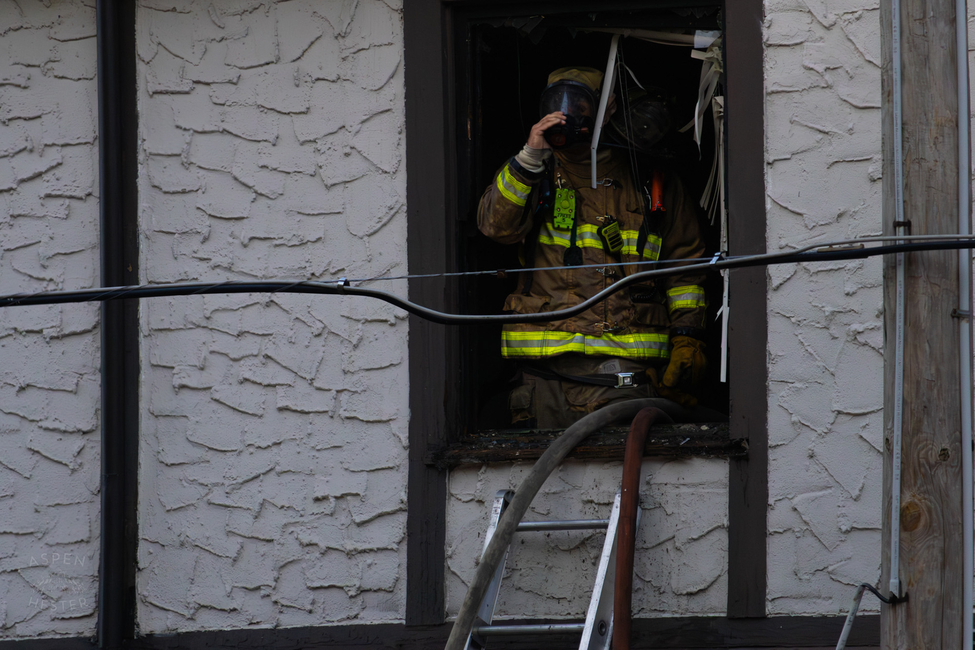 Louisville Firefighter Looking Out of A Burning Building on The Corner of 2nd and Oak Street. June 7th, 2024/Aspen Hester