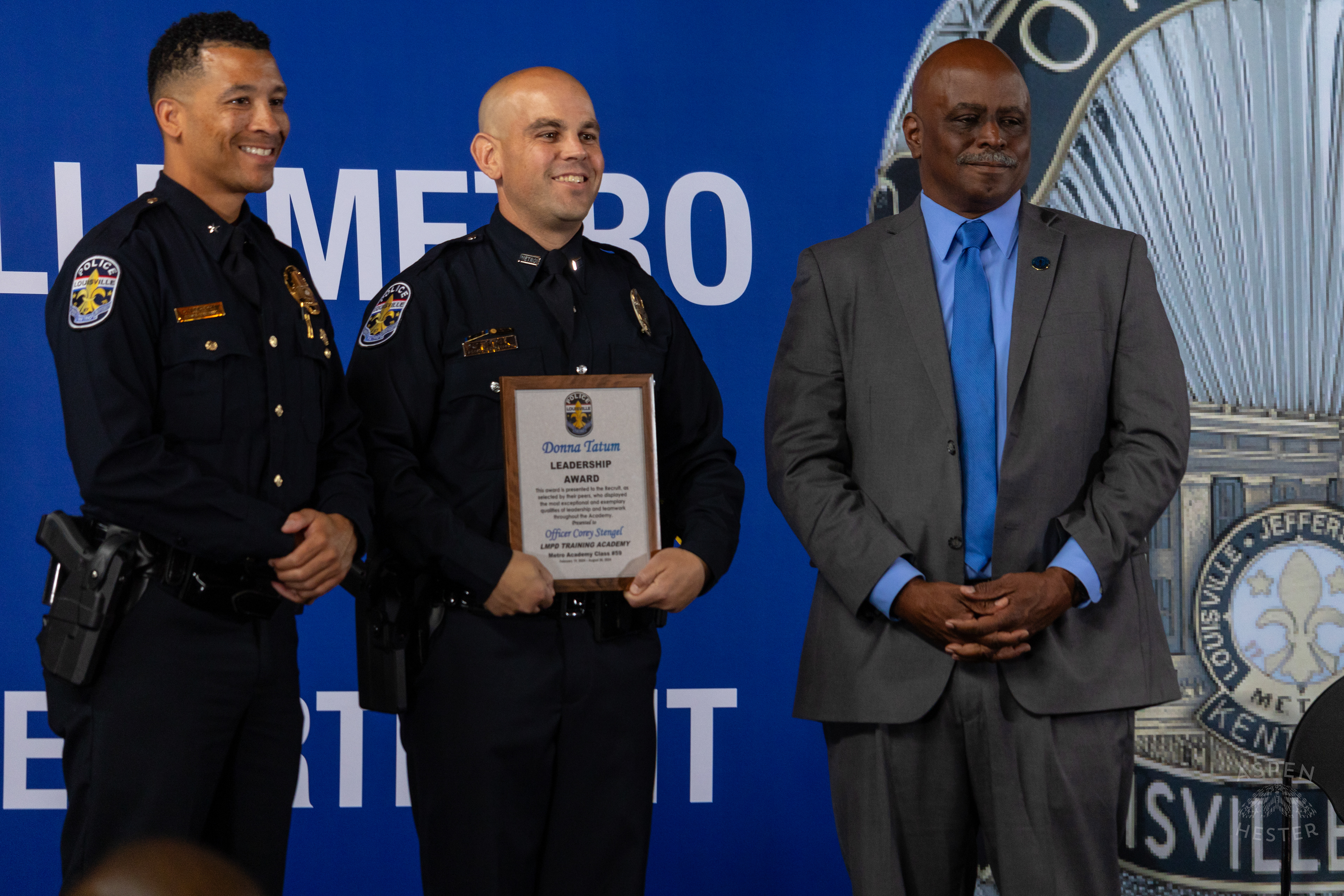Paul Humphrey and David James with Graduating Officer Corey Stengrl as he is Awarded The Donna Tatum Leadership Award at The Graduation of MAC 59 into LMPD. August 30th, 2024Aspen Hester