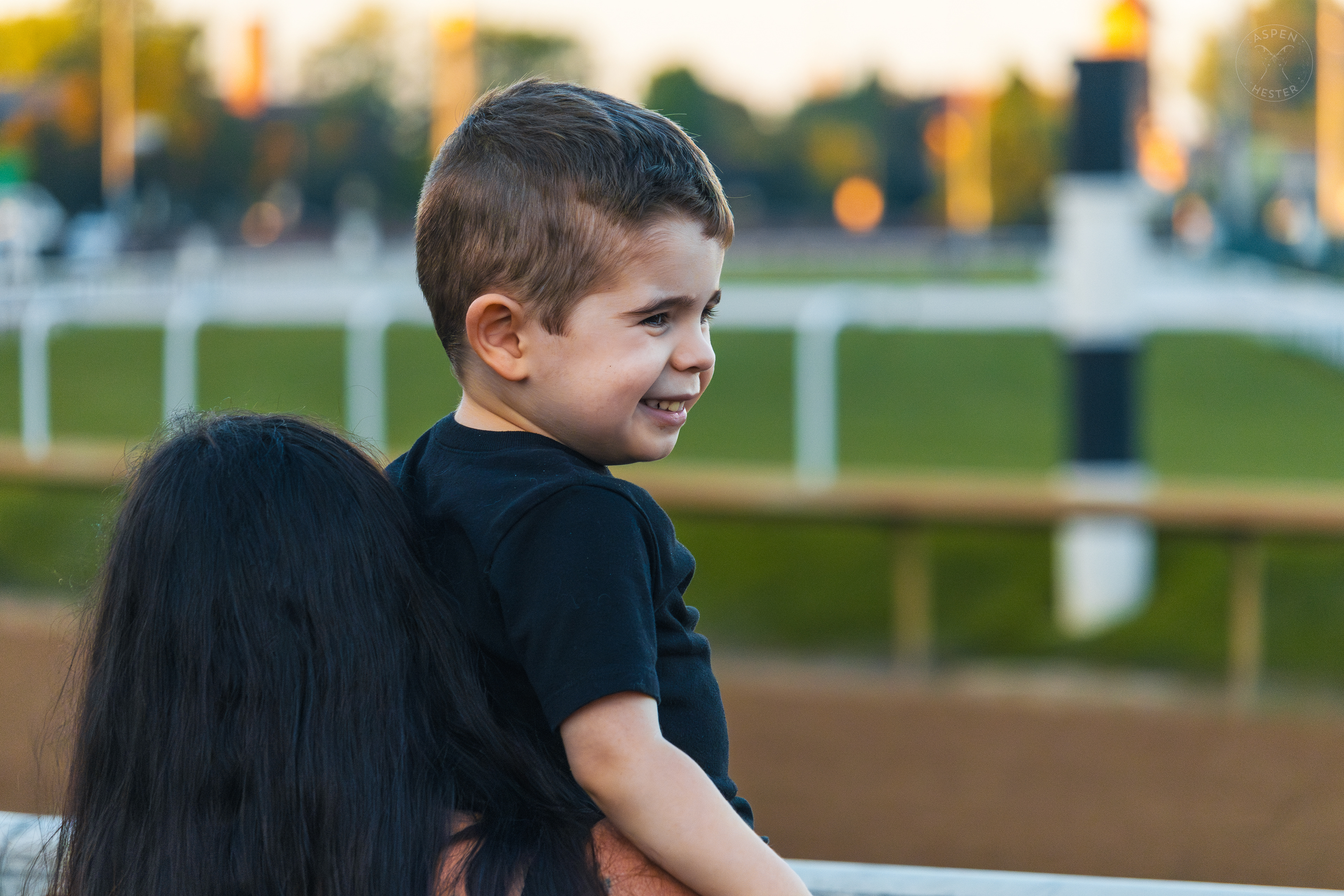 Toddler Watches Horses Race at Downs After Dark. May 18th, 2024/Aspen Hester