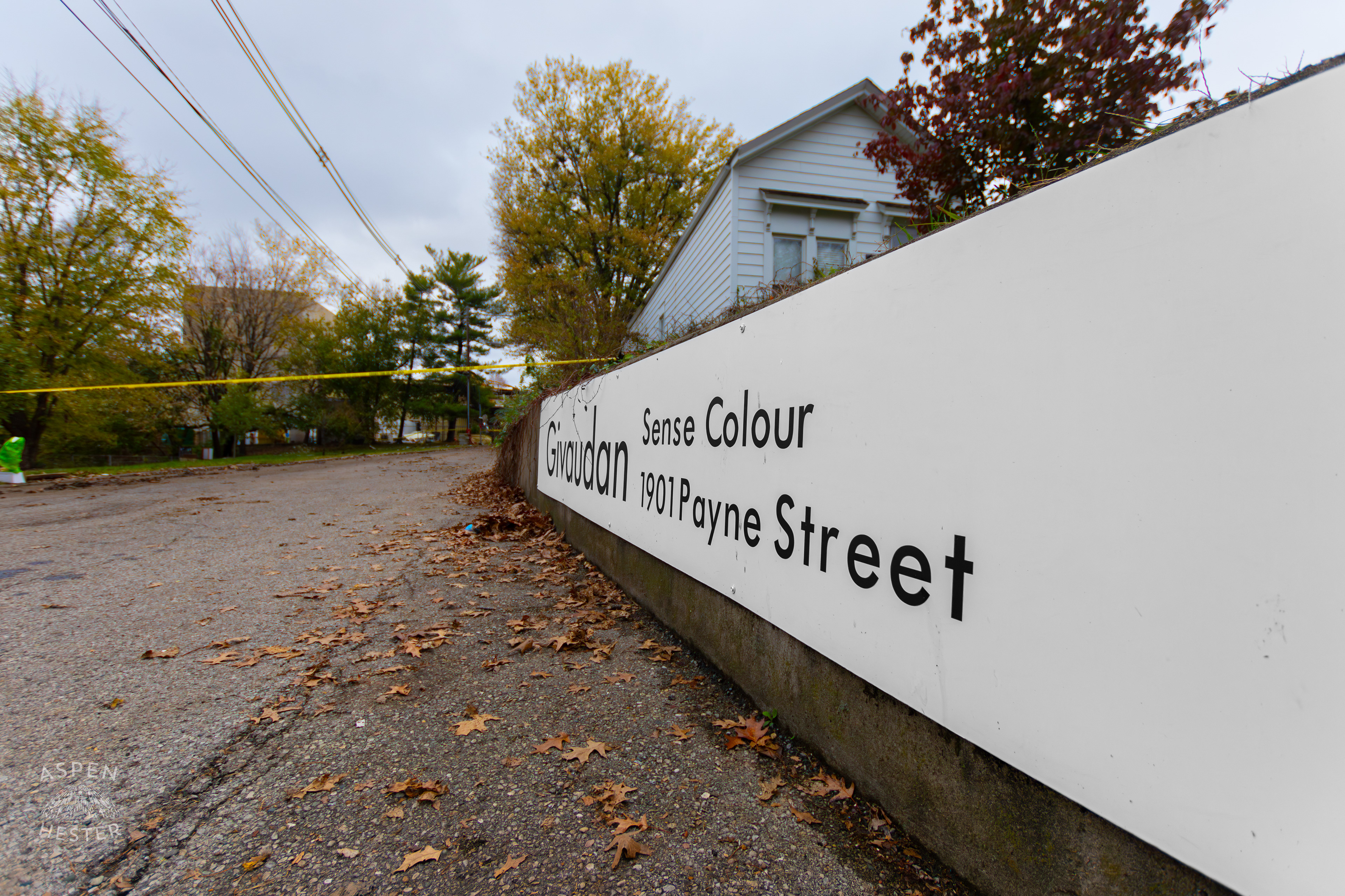 Sign Leading into The Givaudan Sense Colour Plant With the Aftermath of The November 12th Explosion in The Background. November 15th, 2024/Aspen Hester