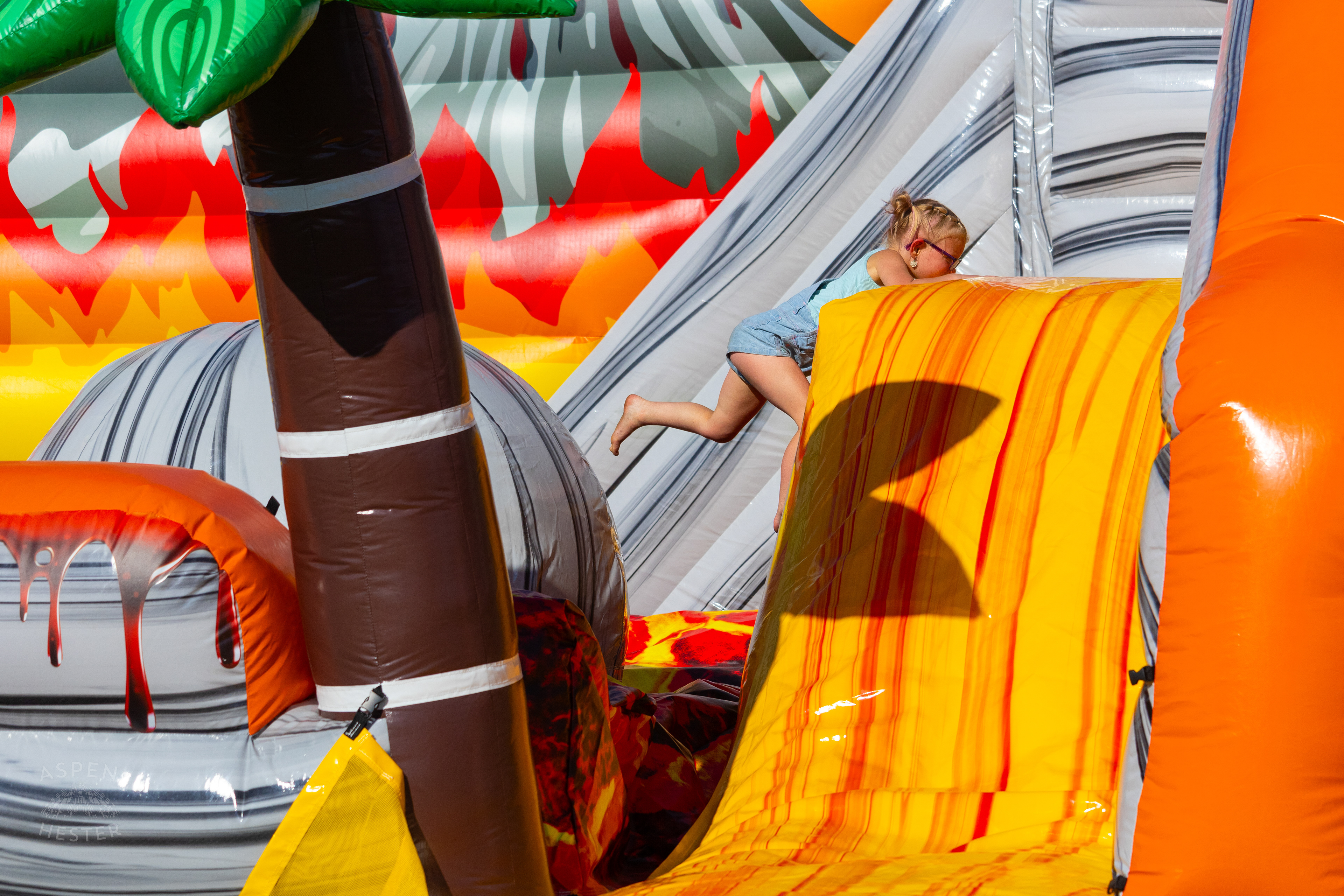 Kid Attempting to Make it Across "The Floor is Lava" at Play America with The Louisville Orchestra. July 5th, 2024/Aspen Hester