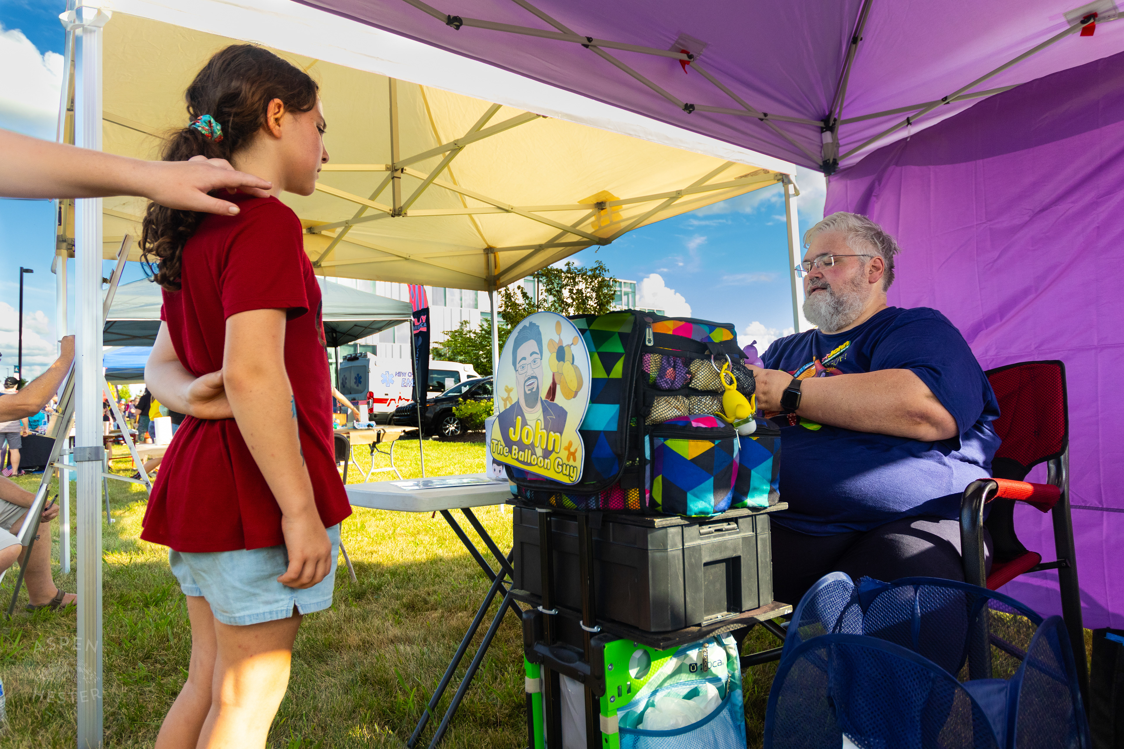 John the Balloon Guy Makes a Balloon Bracelet at Play America with The Louisville Orchestra. July 5th, 2024/Aspen Hester