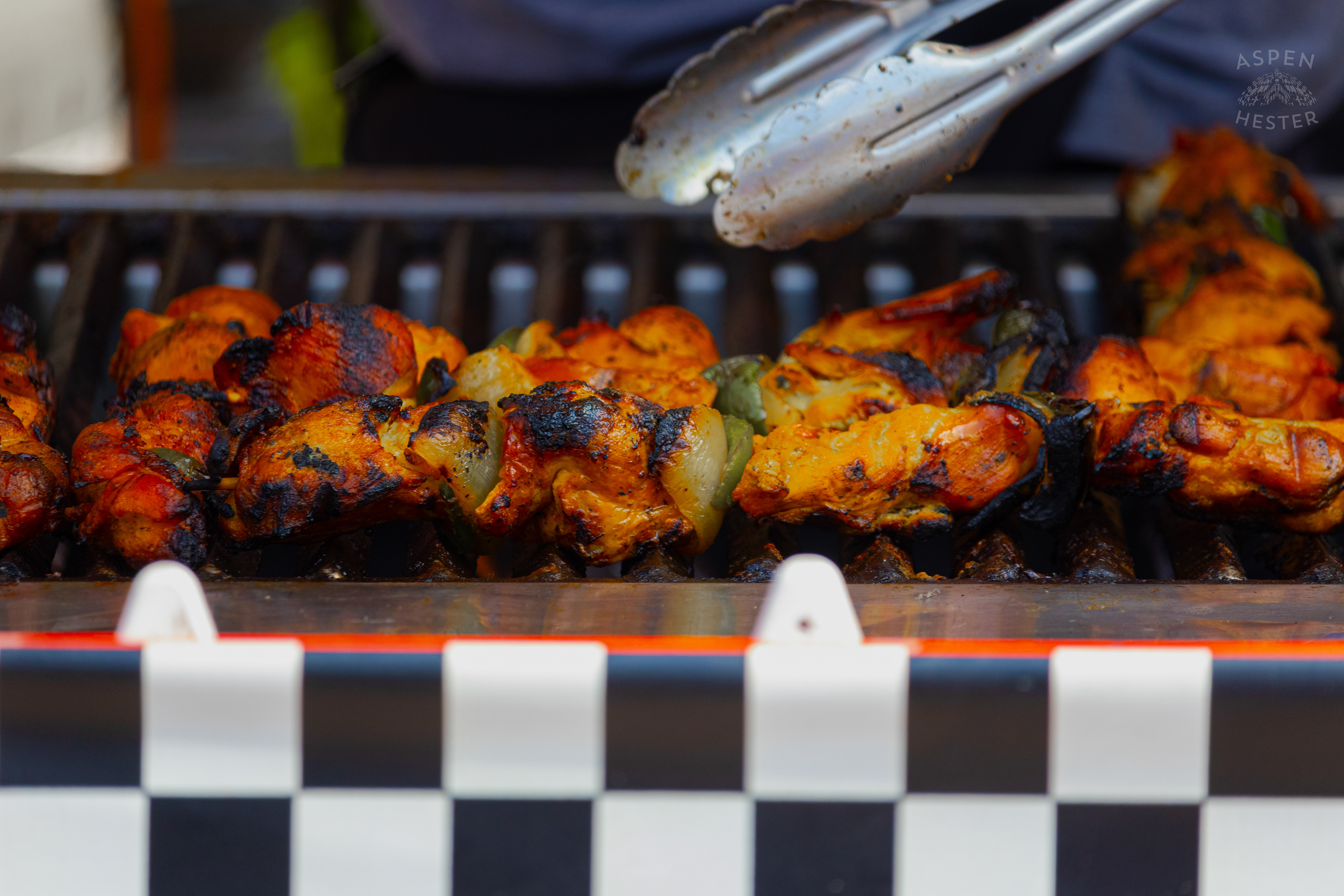 Chef at Enrique's Place Latin Grill Preparing Kabobs for The Opening Day of The 22nd Annual WorldFest. August 30th, 2024. Aspen Hester