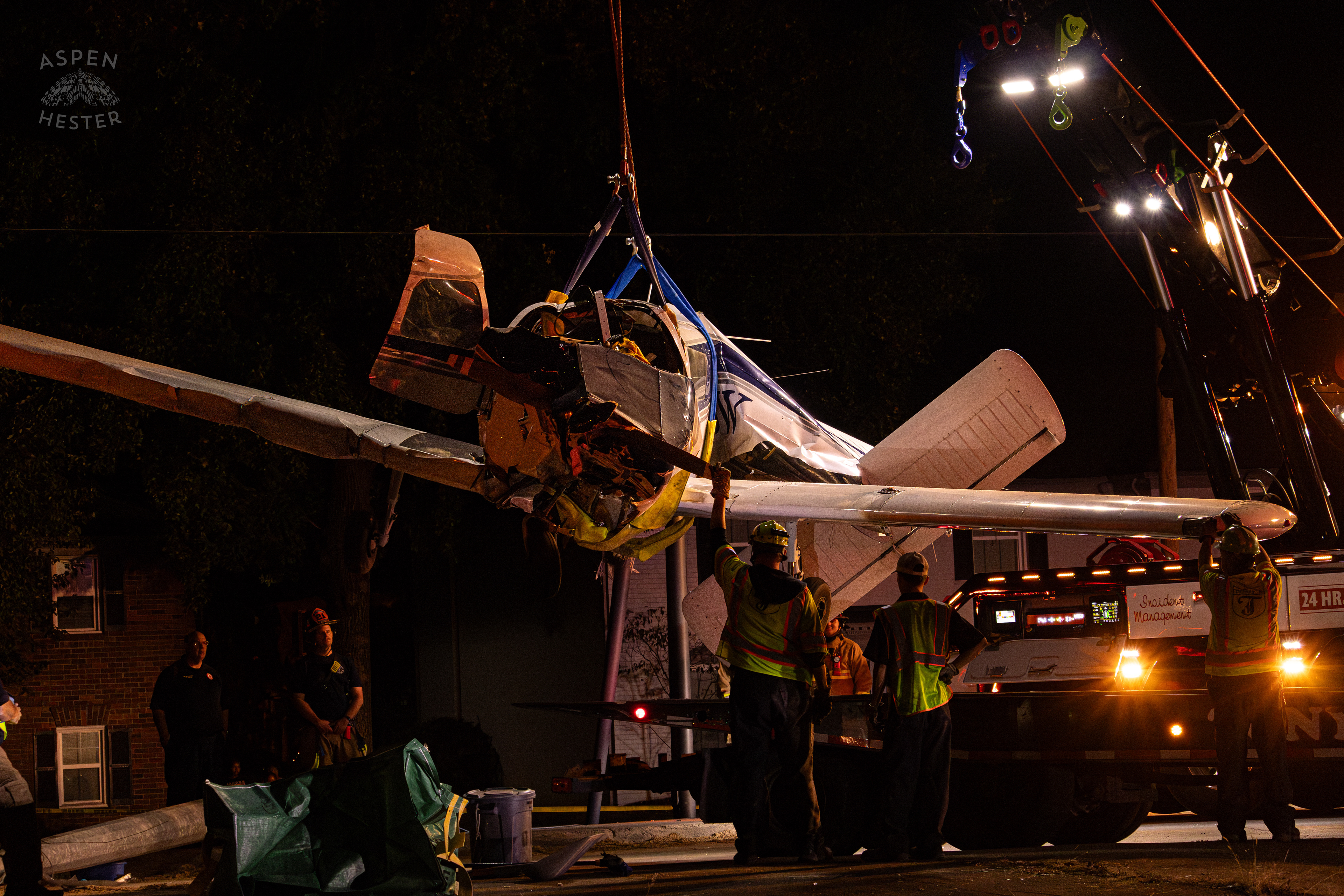 The Piper Cherokee Plane Being Lifted from the Road after it Crash Landed, Taking Out Utility Poles, and Hitting A Car on Breckenridge Lane and Kresge Way. October 11th, 2024/Aspen Hester 