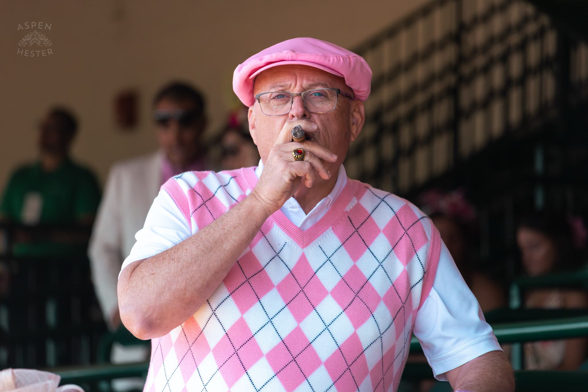 A Dapper Man Enjoys A Cigar at Churchill Downs During Thurby. April 30th, 2026/Aspen Hester