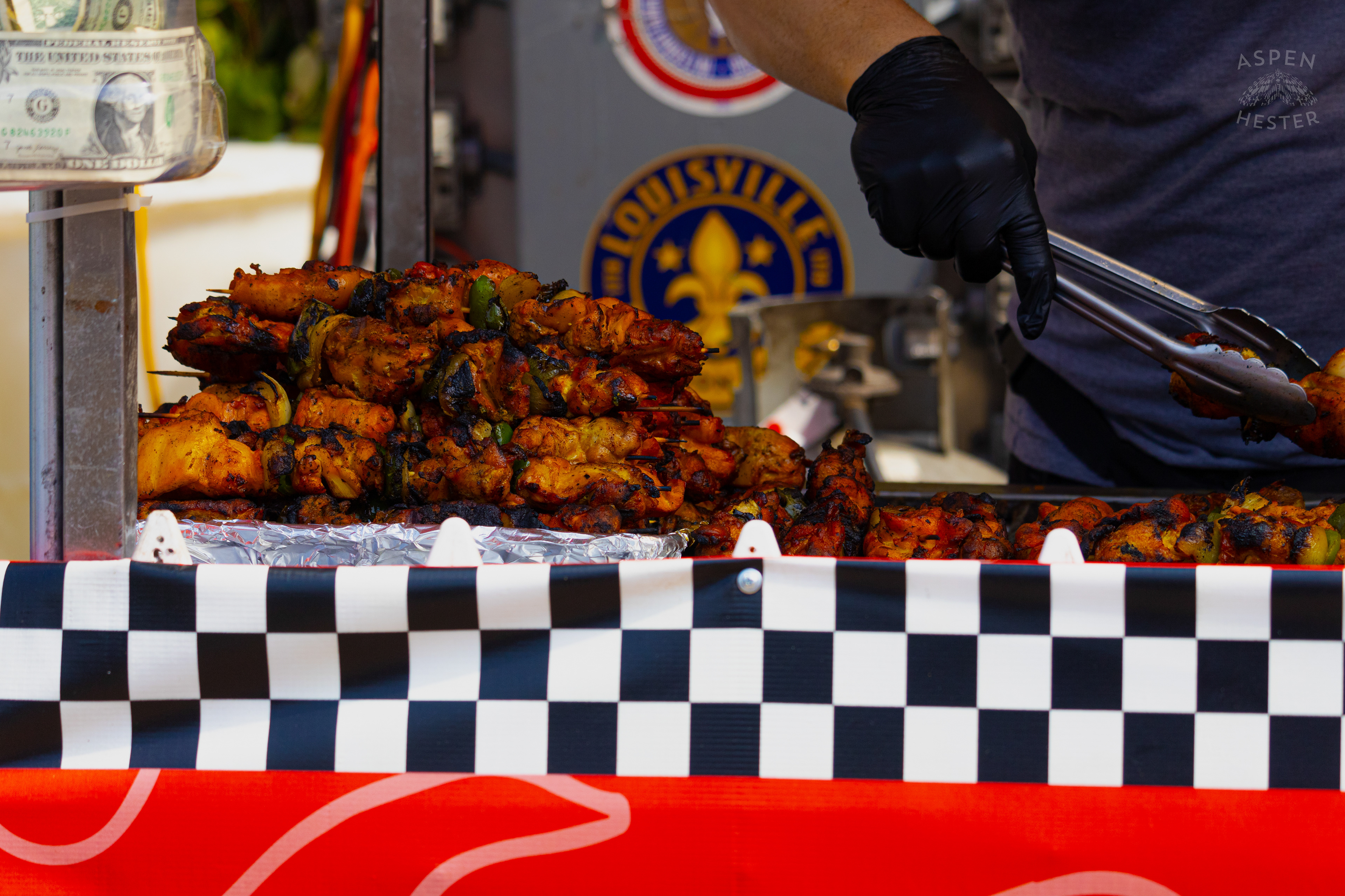 Chef at Enrique's Place Latin Grill Preparing Kabobs for The Opening Day of The 22nd Annual WorldFest. August 30th, 2024. Aspen Hester