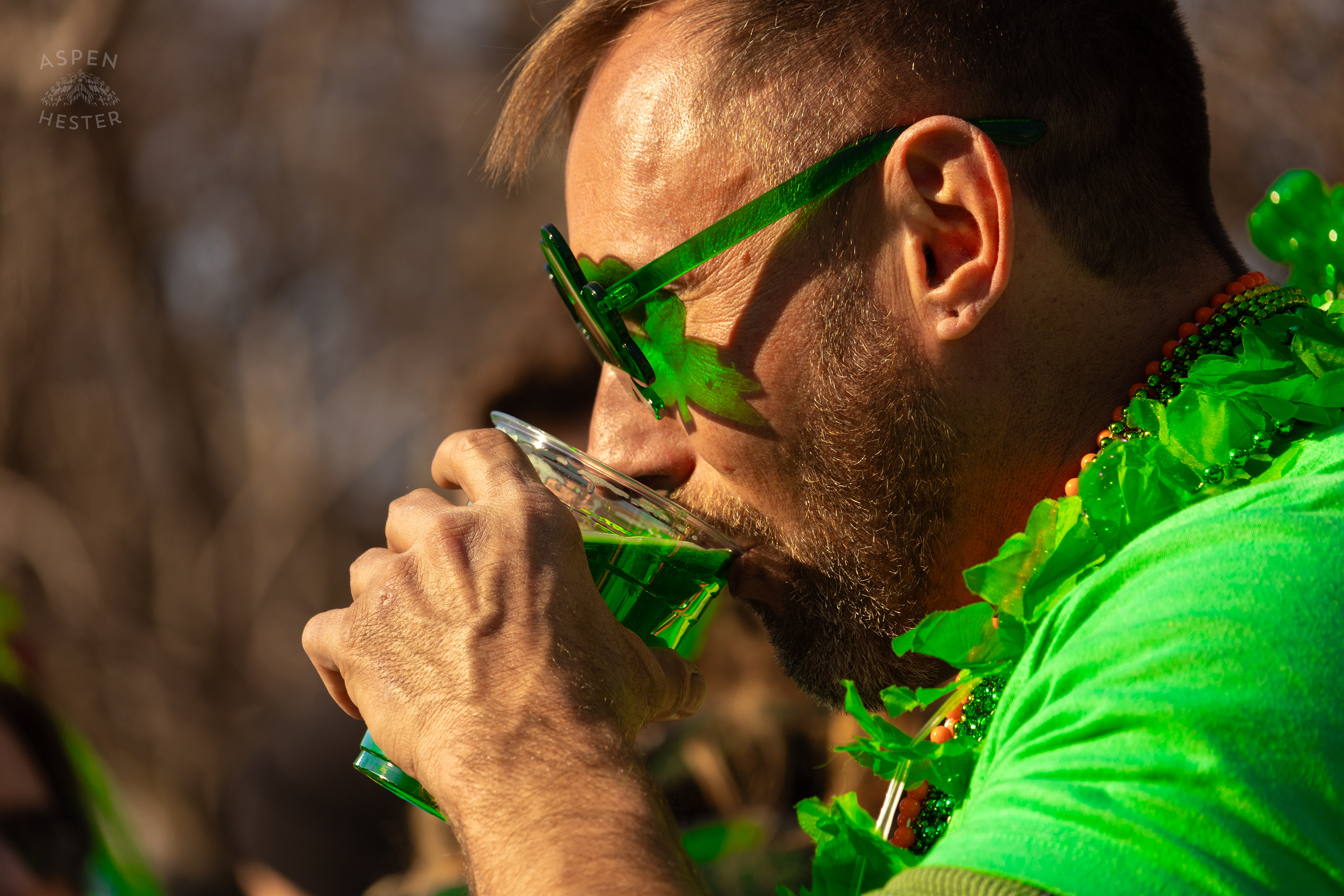 A Spectator Drinks Green Saint Paddy’s Beer as The 52nd Annual Saint Patrick’s Day Parade Rolls Through The Highlands. March 8th, 2025/Aspen Hester