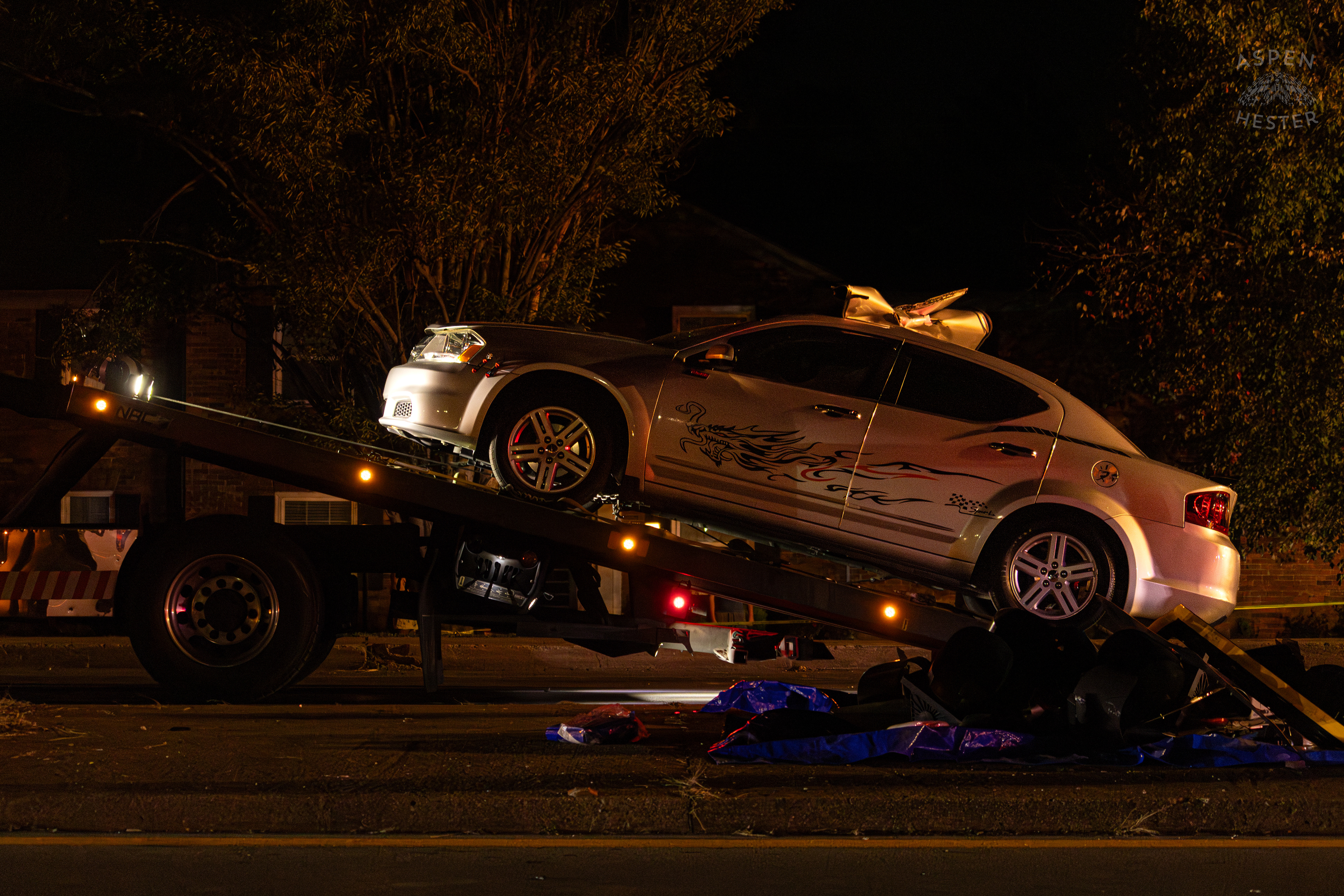 The Mangled Dodge Charger being Towed Away after A Piper Cherokee Plane Crash Landed, Taking Out Utility Poles, and Hitting This Car on Breckenridge Lane and Kresge Way. October 11th, 2024/Aspen Hester 