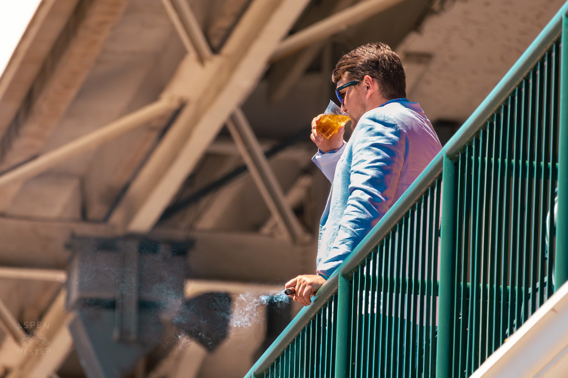 Drinking Bourbon and Smoking A Cigar from The Balcony at Churchill Downs During Thurby. April 30th, 2026/Aspen Hester