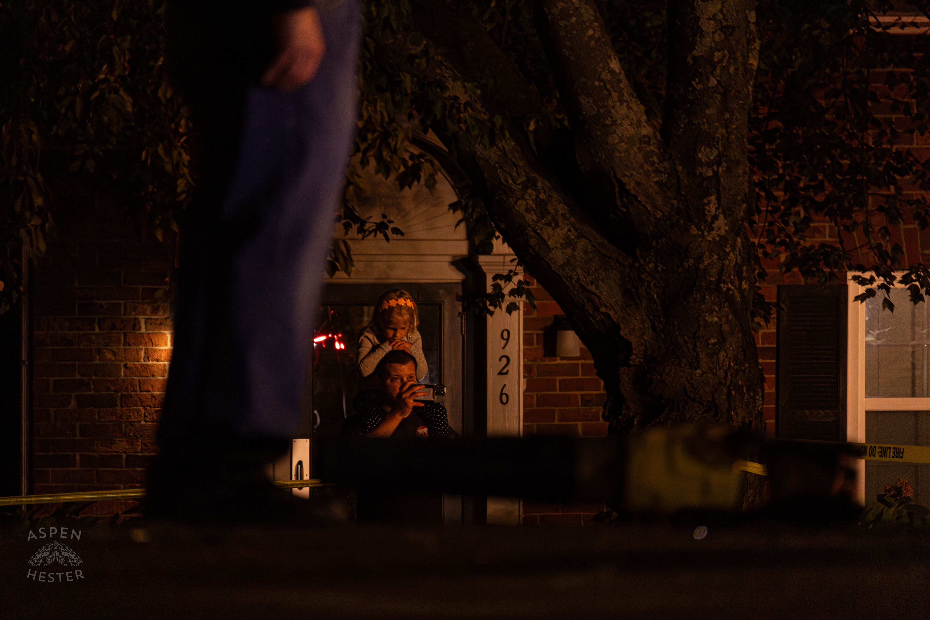 Onlookers Watching as Tony's Wreckers Crew Works to Remove The Piper Cherokee Plane from the Road after it Crash Landed, Taking Out Utility Poles, and Hitting A Car on Breckenridge Lane and Kresge Way. October 11th, 2024/Aspen Hester