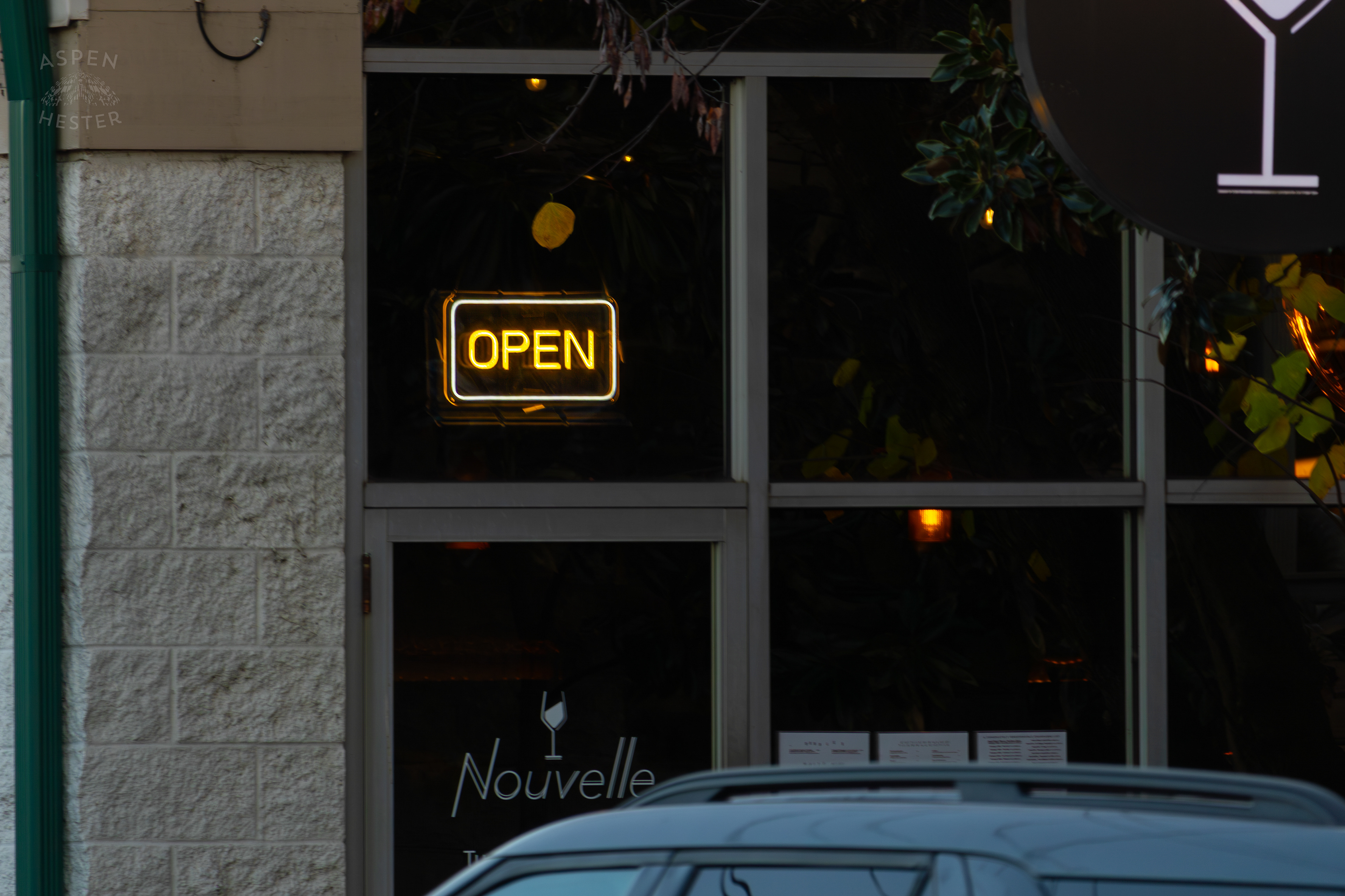 Open Sign Displayed by Nouvelle In Nulu on A Saturday Evening. November 14th, 2024/Aspen Hester