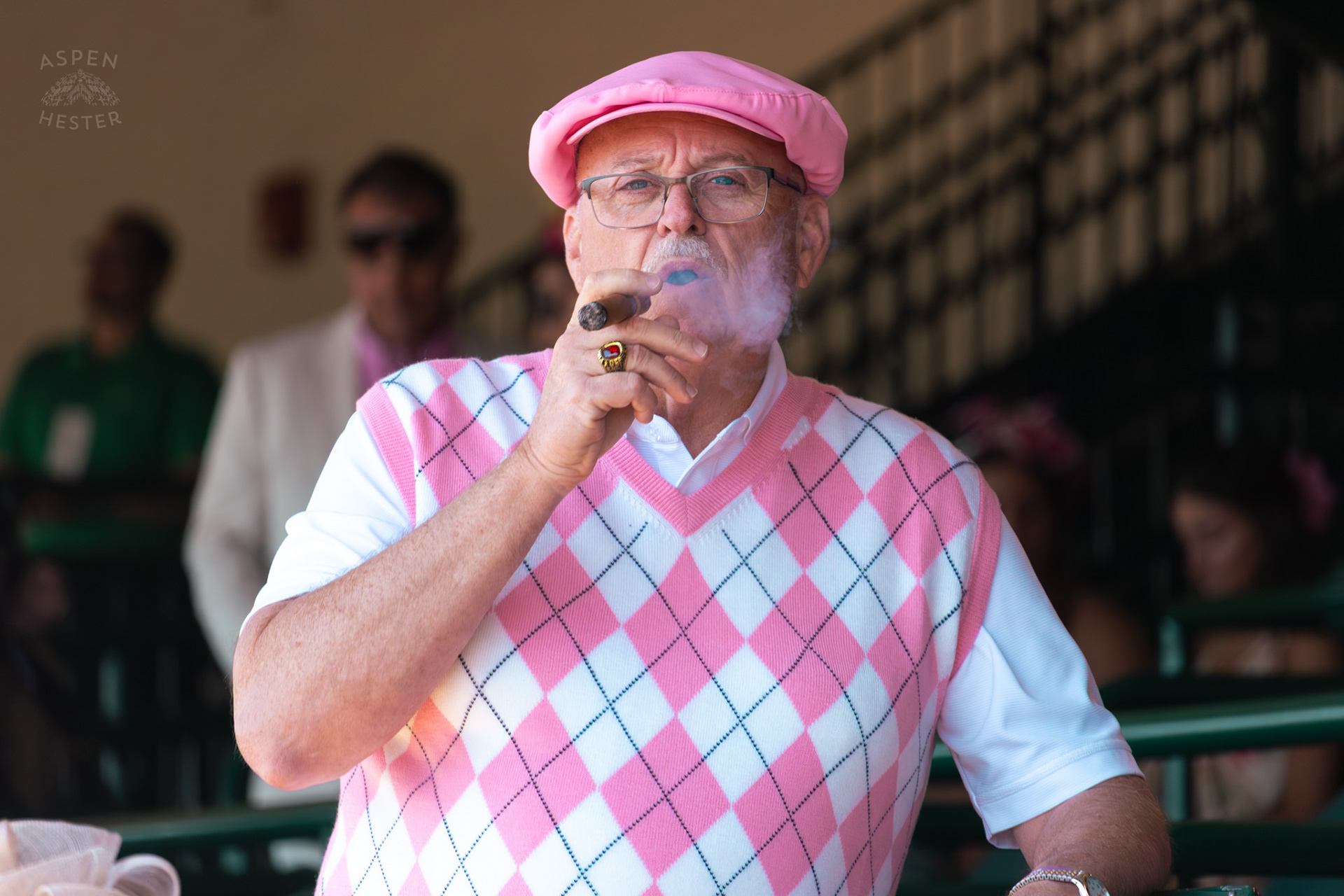 A Dapper Man Enjoys A Cigar at Churchill Downs During Thurby. April 30th, 2026/Aspen Hester