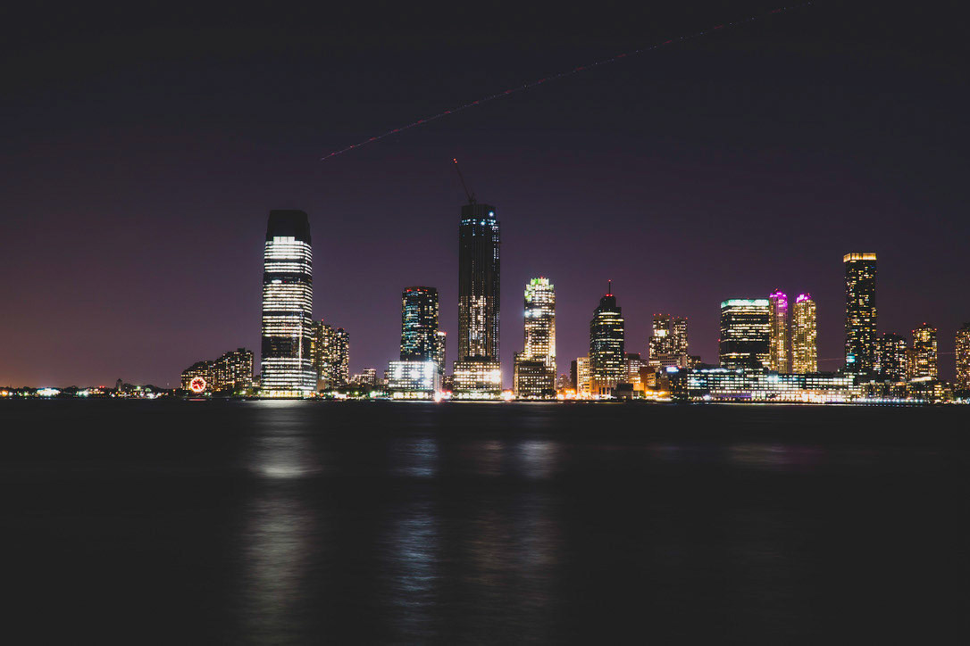Night time cityscape of Jersey City, NJ.