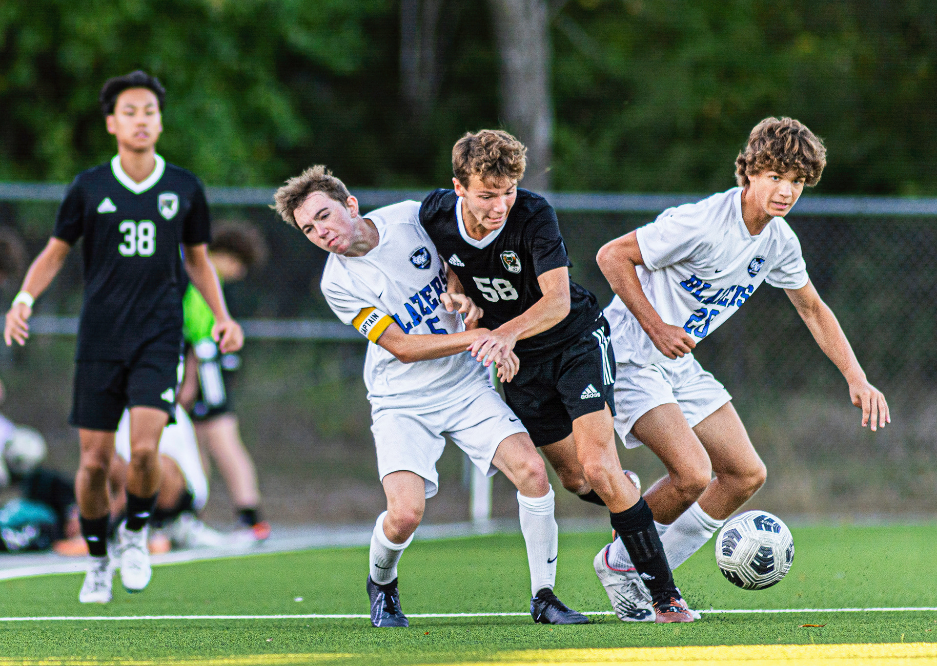 Pushing through: With his eyes on the ball, Free State sophomore Caleb Huggins attempts to fight past defenders of Gardner Edgerton at the JV soccer game on Oct 3. Free State ended up winning 2-0, and now has a season record of 5-3-2.