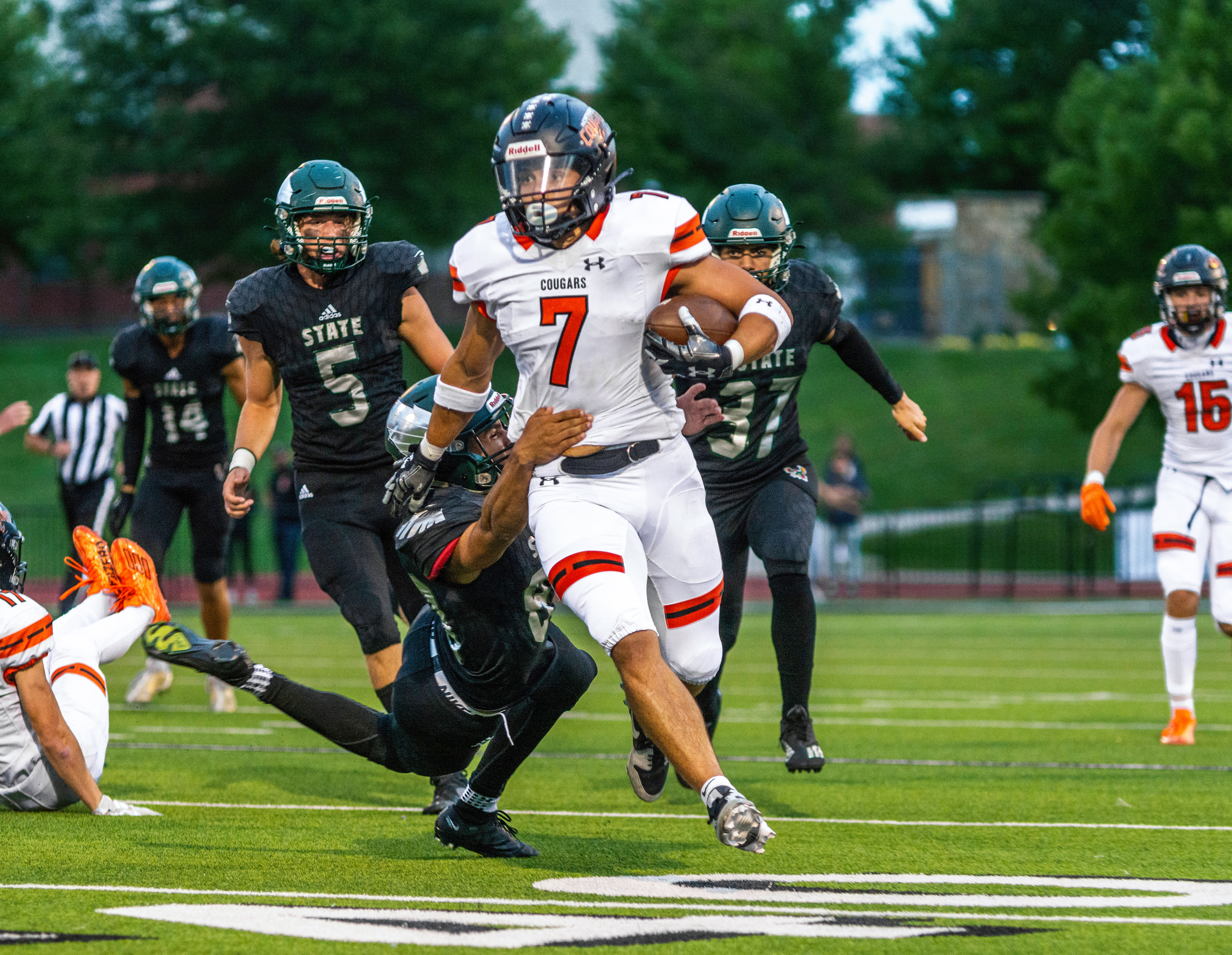 Almost to a Touchdown: Running past Free State defenders, senior Gabe Hoskins from Shawnee Mission Northwest is pulled down by Free State junior Bralin Preston at the 40-yard line. Free State football defeated the Cougars 28-6.