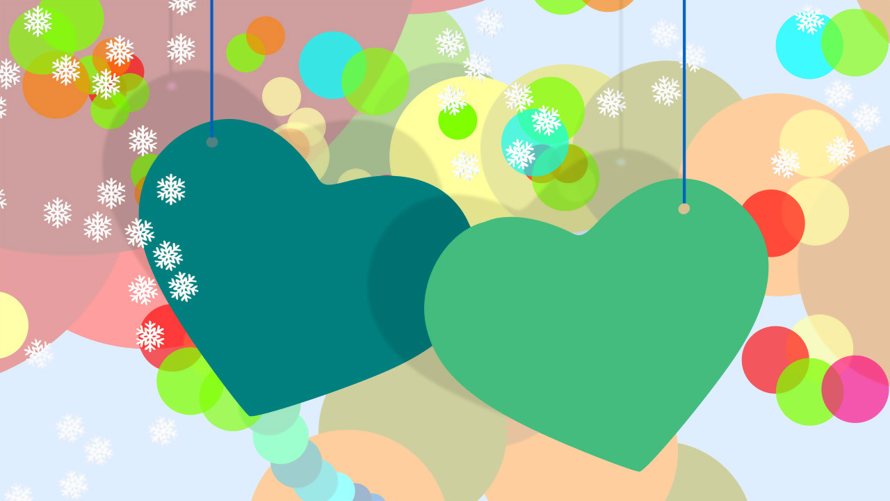Dos enormes siluetas de corazones verdes colgados de hilos sobre colorido fondo bokeh y copos de nieve. #TeneNavidad