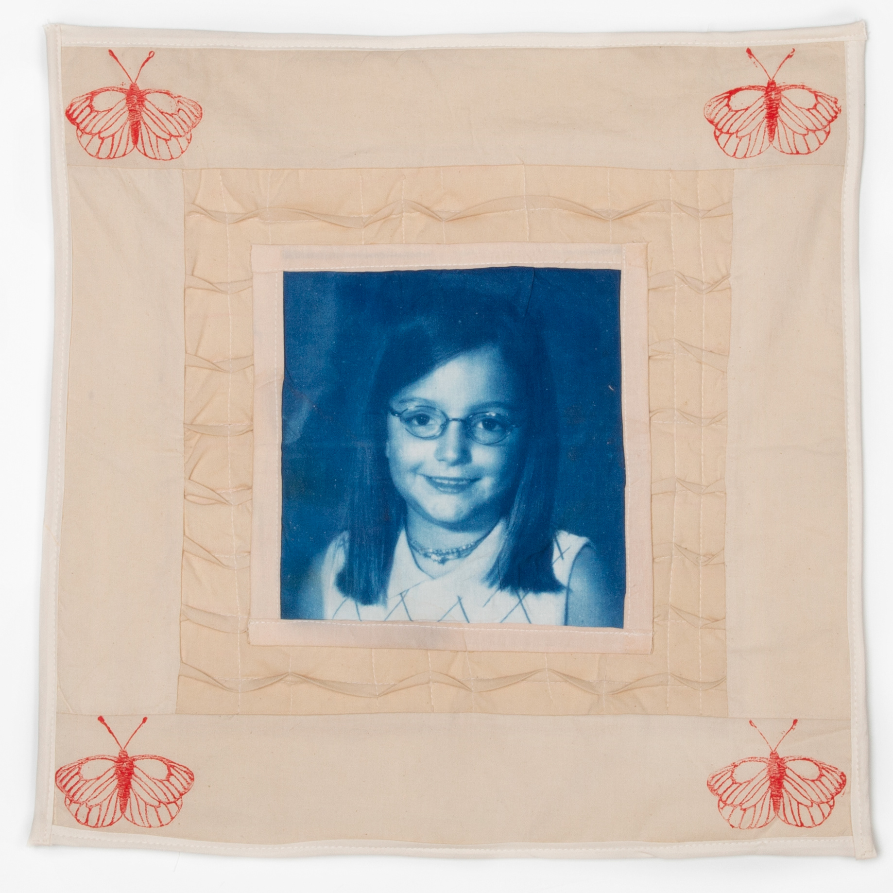 Cotton cyanotype print, machine quilted, cotton fabrics dyed with tea and coffee, cotton batting, and laser-etched stamp. 17.5" x 17.5"