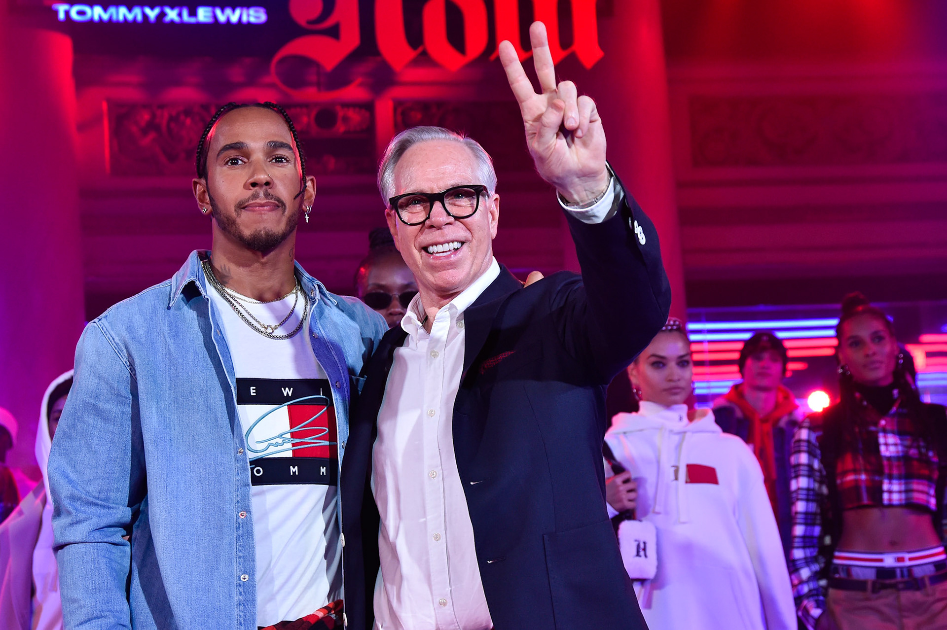 Lewis Hamilton and Tommy Hilfiger acknowledges the audience at the end of the Tommy Hilfiger presentation in Milan during the Milan Fashion Week Spring/Summer 2020 on September 16, 2019 in Milan, Italy.