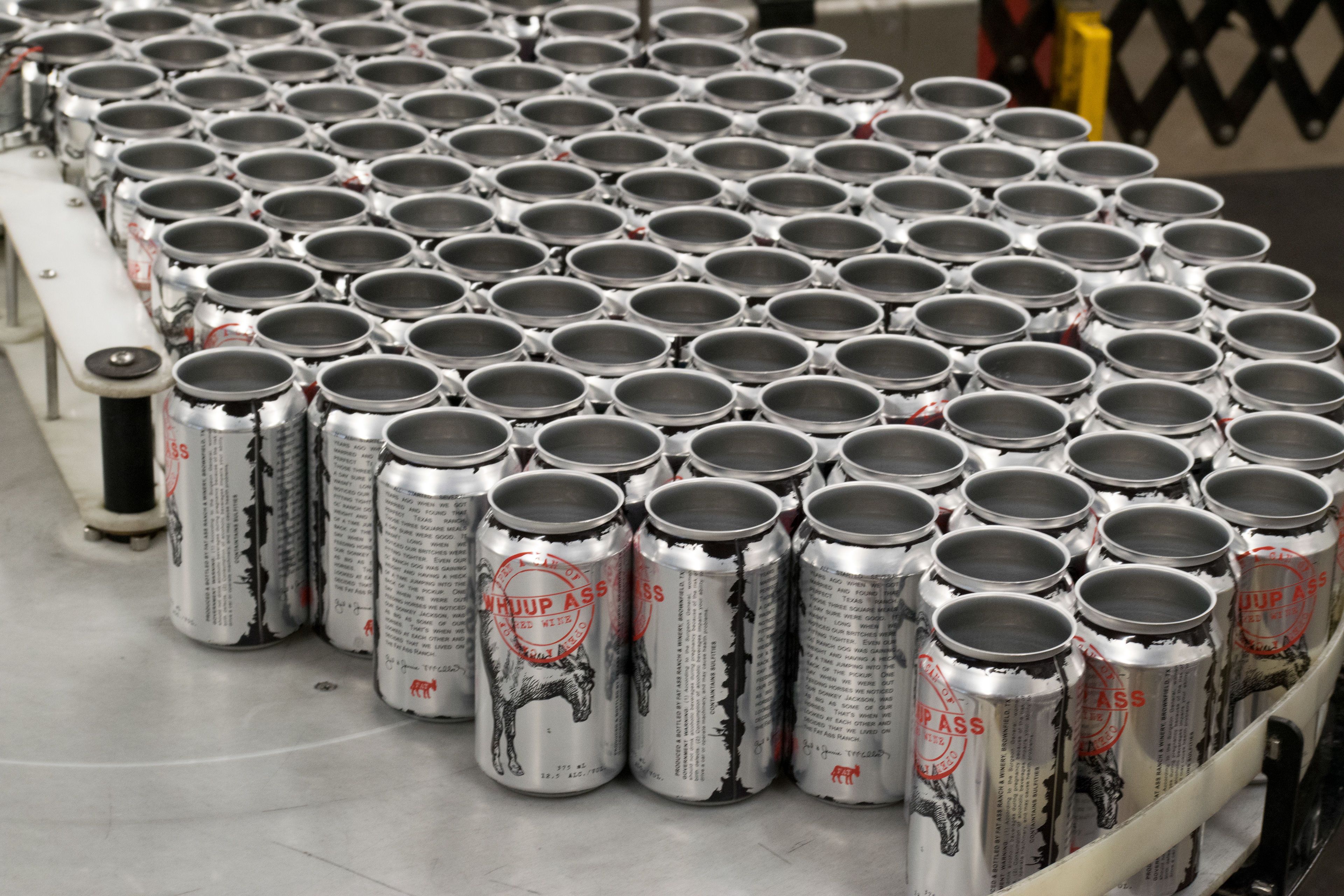Whuup Ass cans load and waiting to be filled