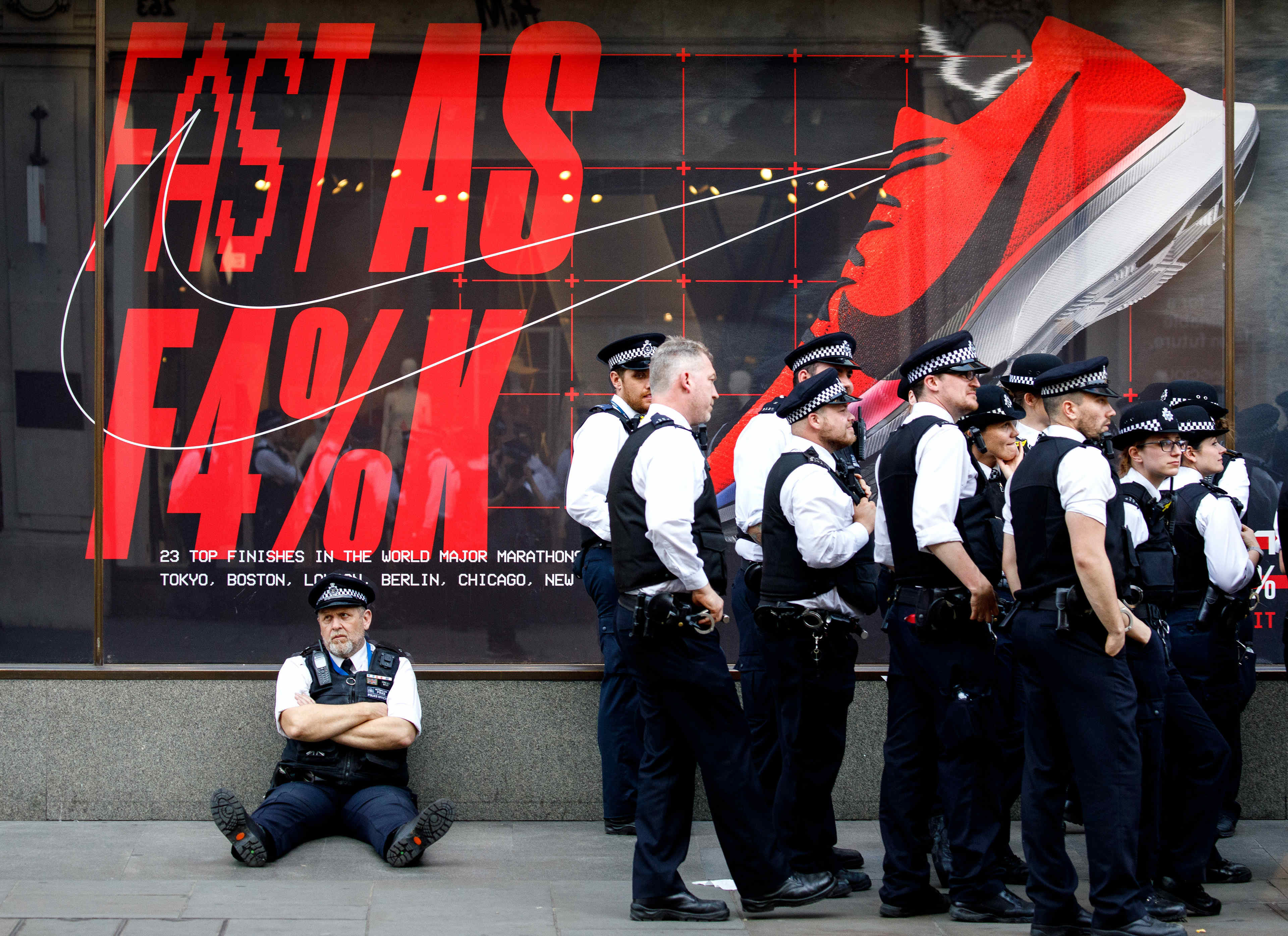 Police officers are seen standing outside a shop on Oxford Street
