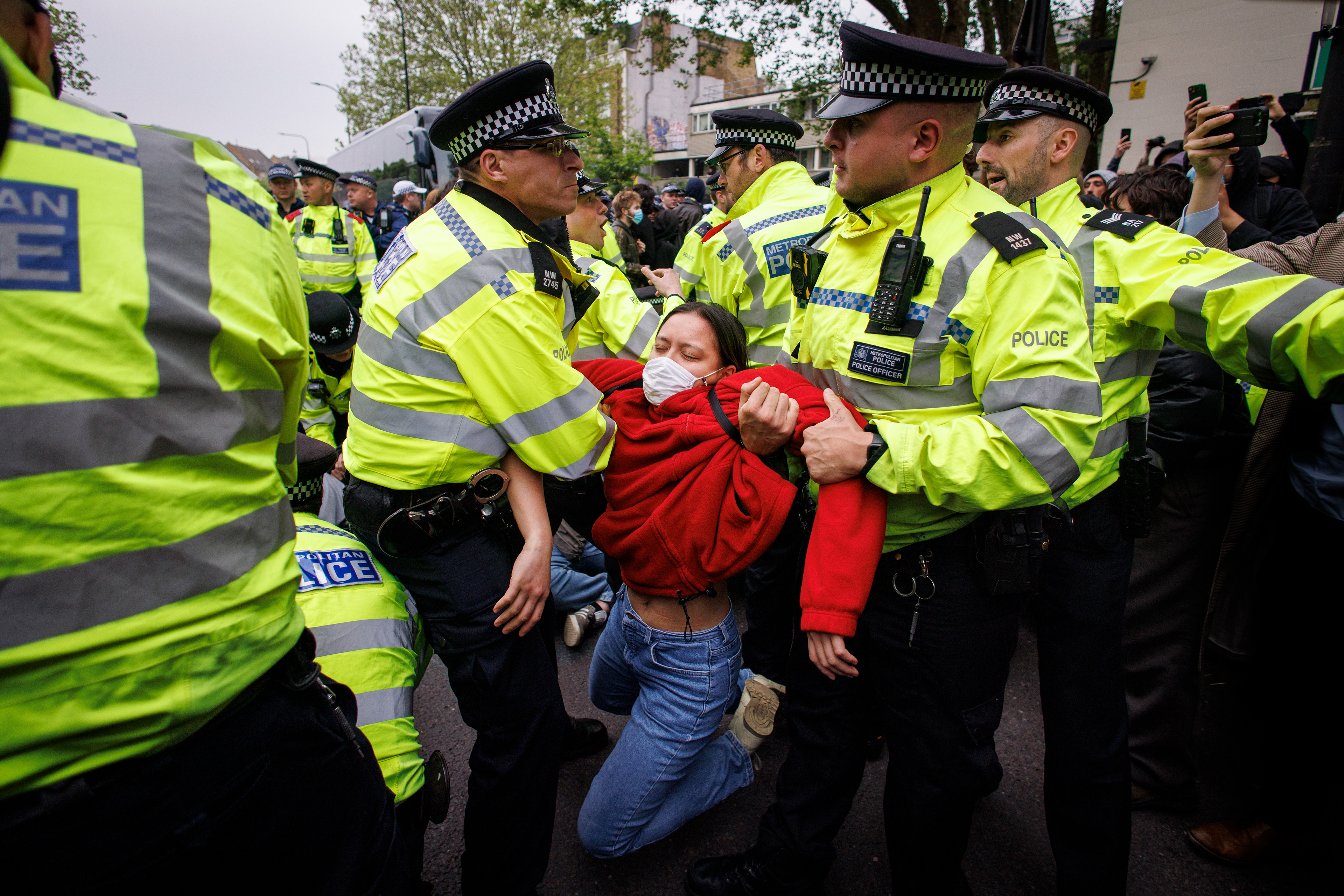 Police officers make arrests to break a blockade around a coach, which was due to remove asylum seekers from a hotel