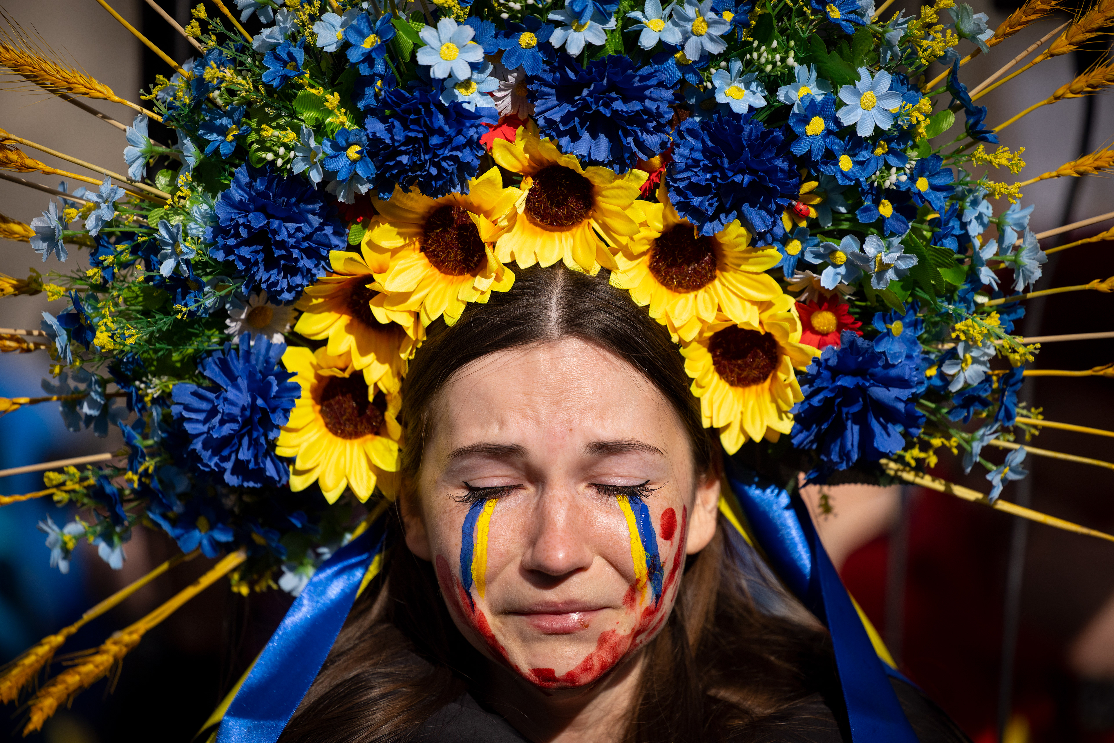 People hold placards and blood splattered fake-babies at a protest in support of Ukraine on Whitehall in central London on April 9, 2022.