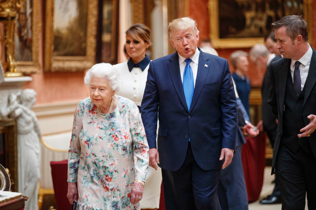 Britain's Queen Elizabeth II views a display of US items of the Royal collection with US President Donald Trump at Buckingham palace at Buckingham Palace in central London on June 3, 2019, on the first day of their three-day State Visit to the UK.