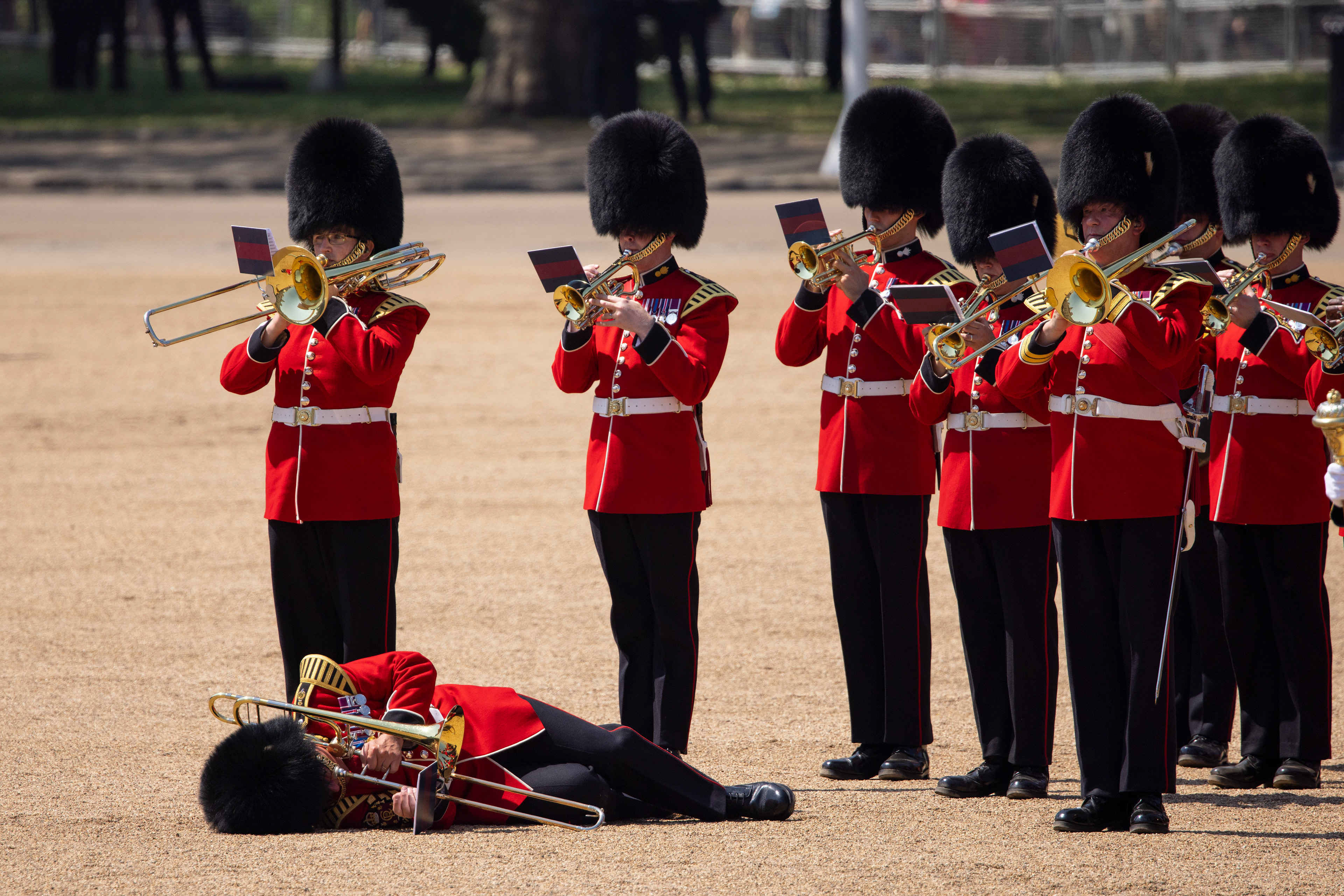 A member of the Massed Bands of the Household Division faints due to heat exhaustion whilst participating in the Colonel's Review