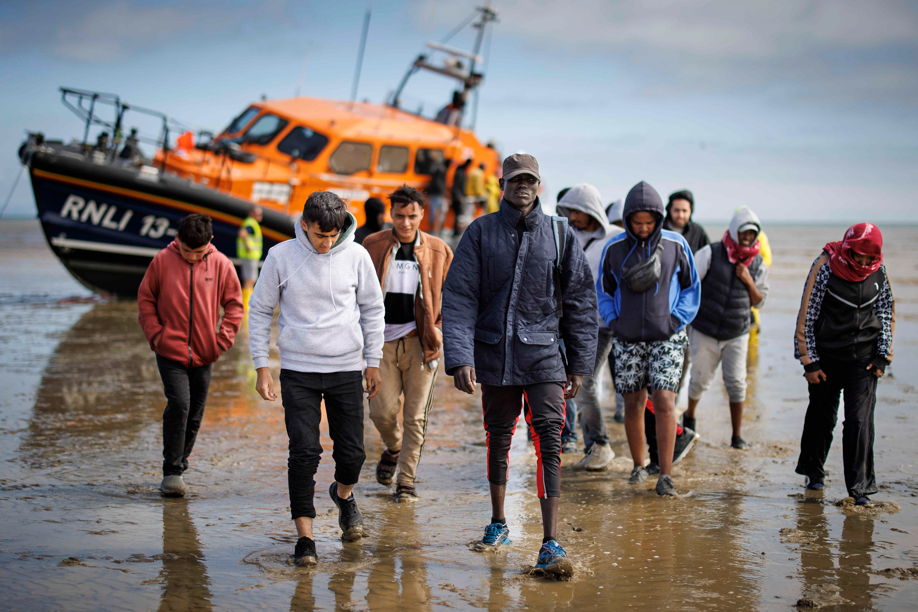 Migrants cross the English Channel on a small boat