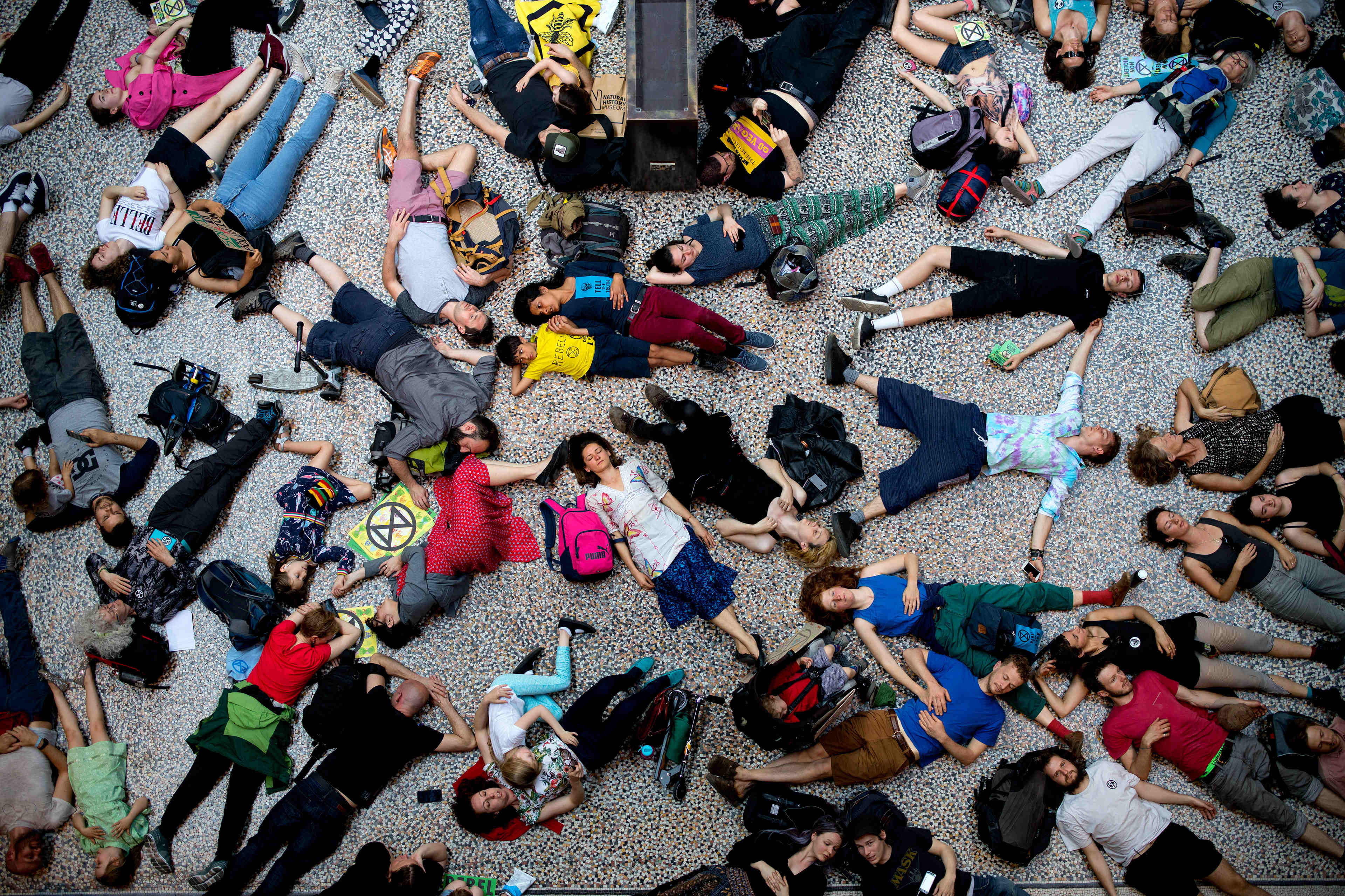 Extinction Rebellion climate change activists lie on the floor as they perform a mass "die in"