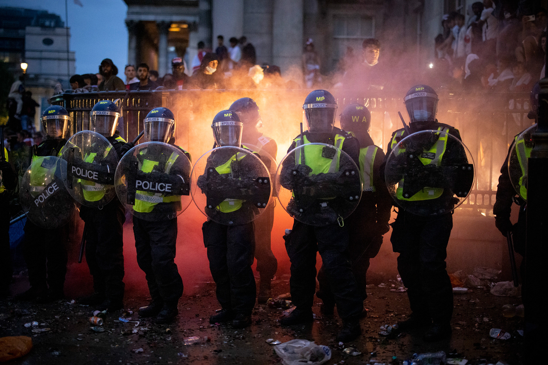 Police officers monitor England fans during the UEFA EURO 2020 final football match