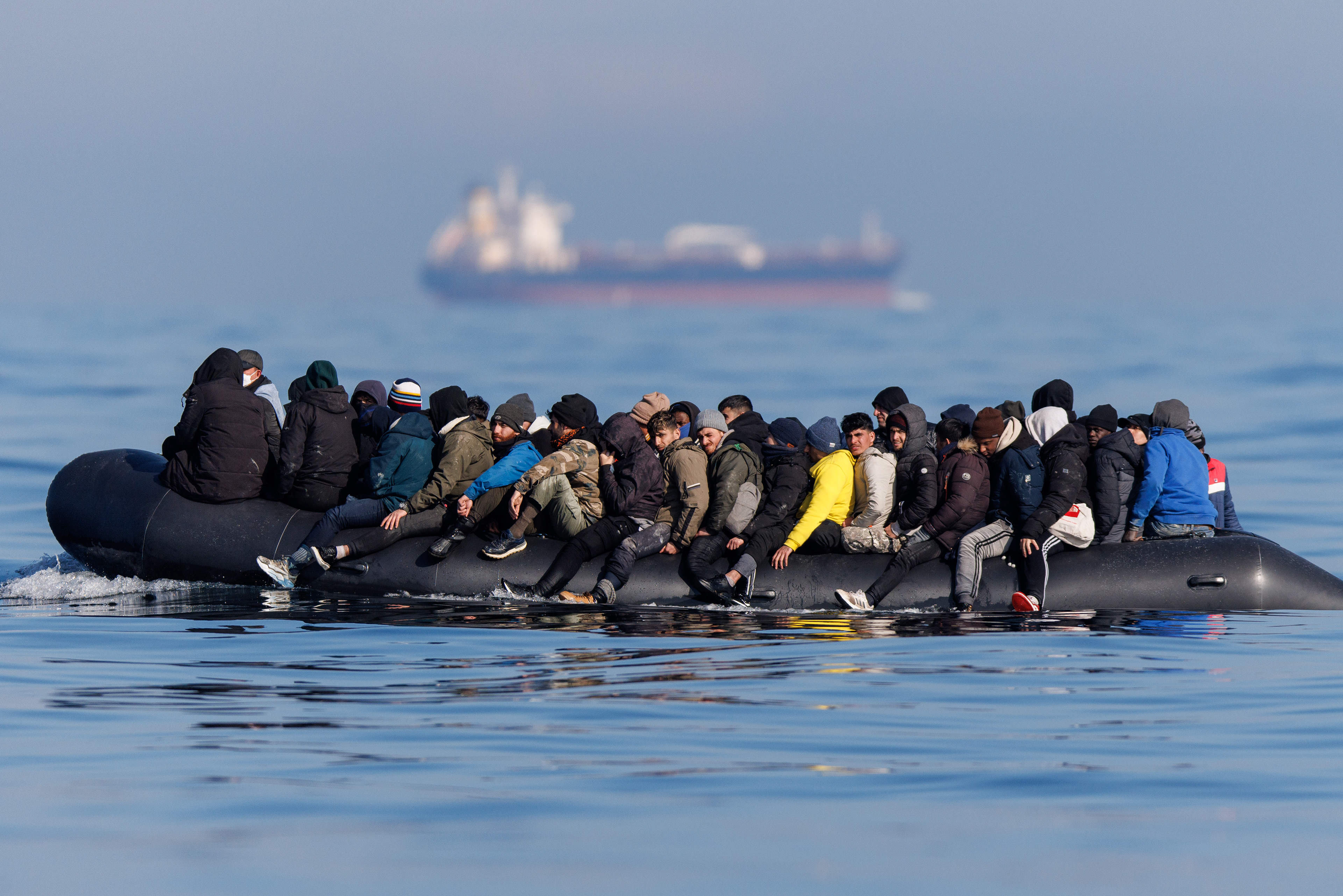 Migrants cross the English Channel on a small boat