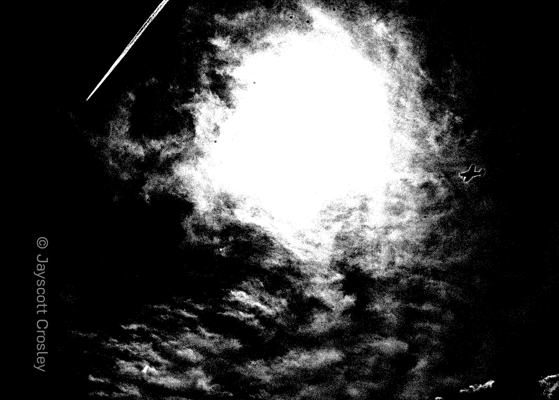 High_Contrast_Safari_Danvers_MA_Planes of Aircraft_A small engine plane travels through the clouds towards the sunlight as a jet streaks across the far end of the sky at the Swampwalk om Damvers Ma_f/16_1/1250/ISO 100_photo by Jayscott Crosley