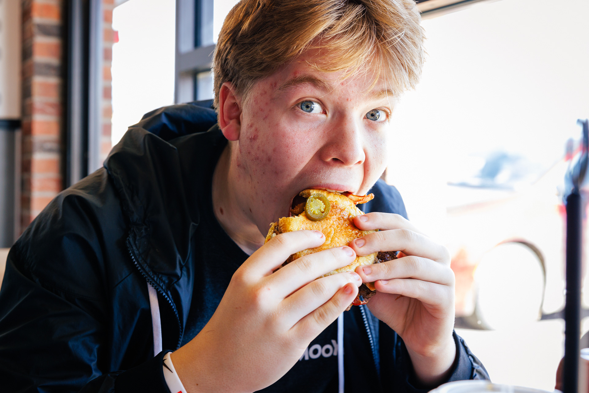 Kid eating Hamburger at Mooyah's
