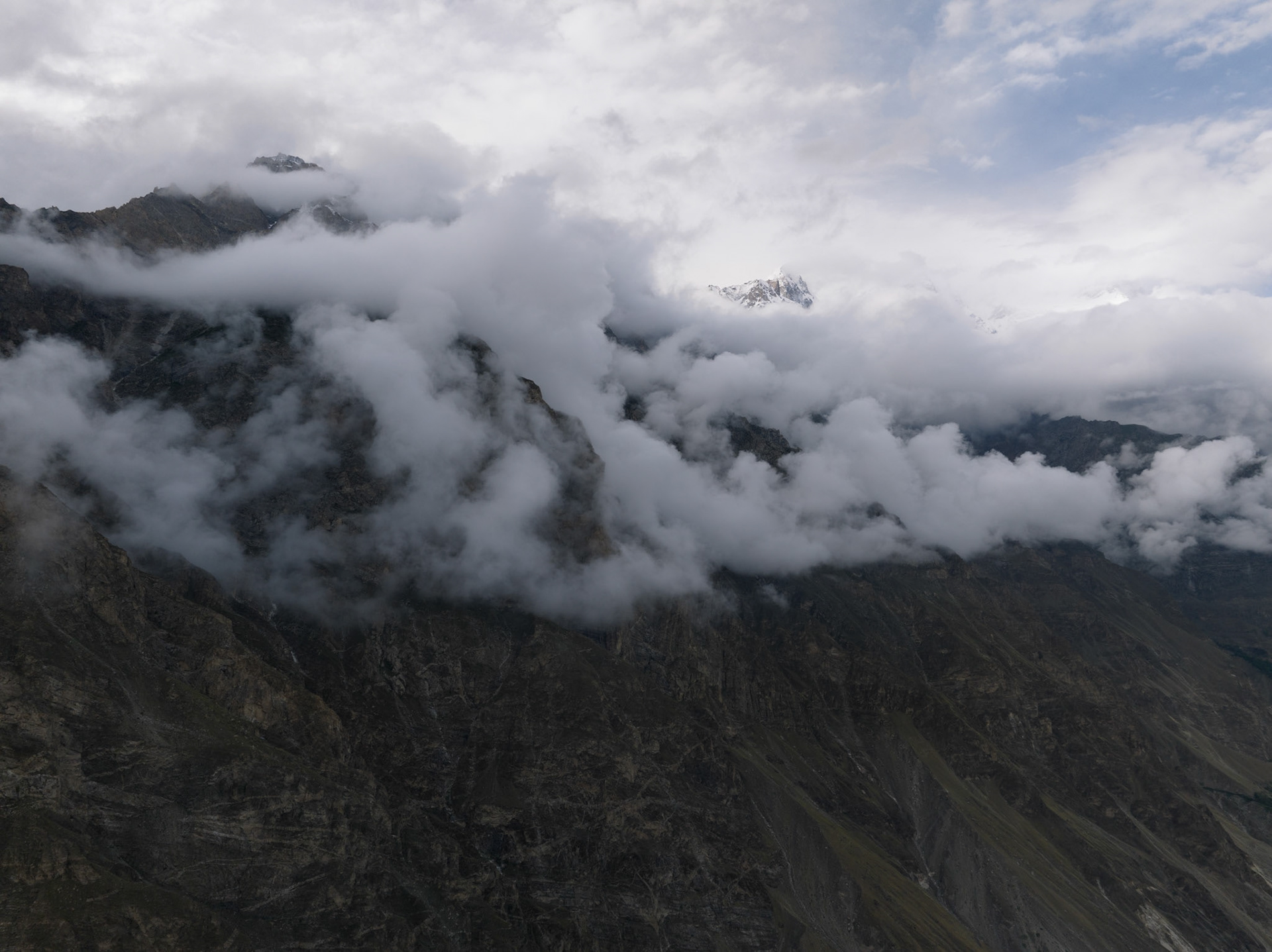Aerial View: Sunrise over Cloud-Shrouded Ultar Peak, Hunza Valley, Pakistan