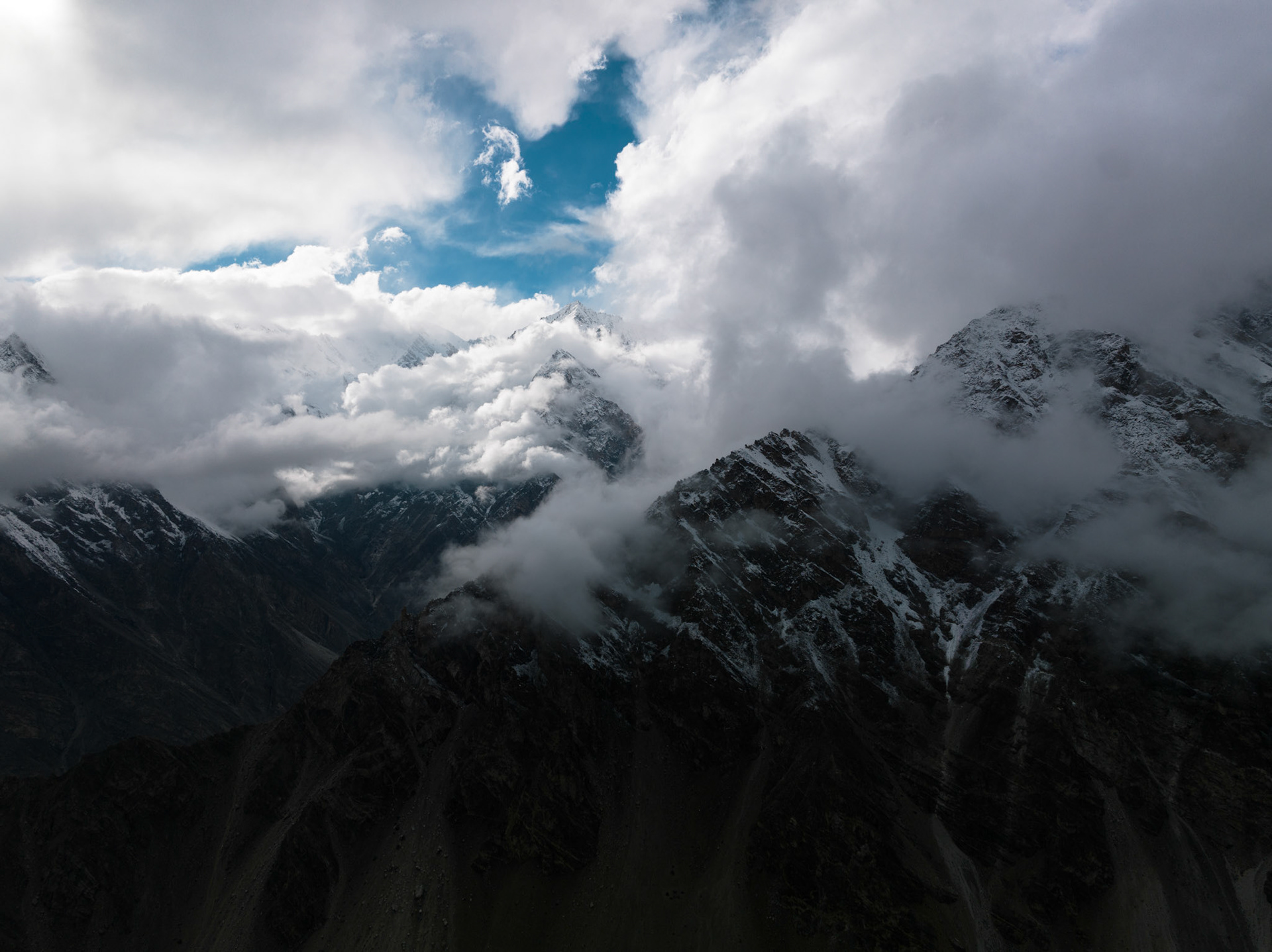 Aerial view of clouds sourronding high peaks in the Himalayas, Hunza Valley, Pakistan
