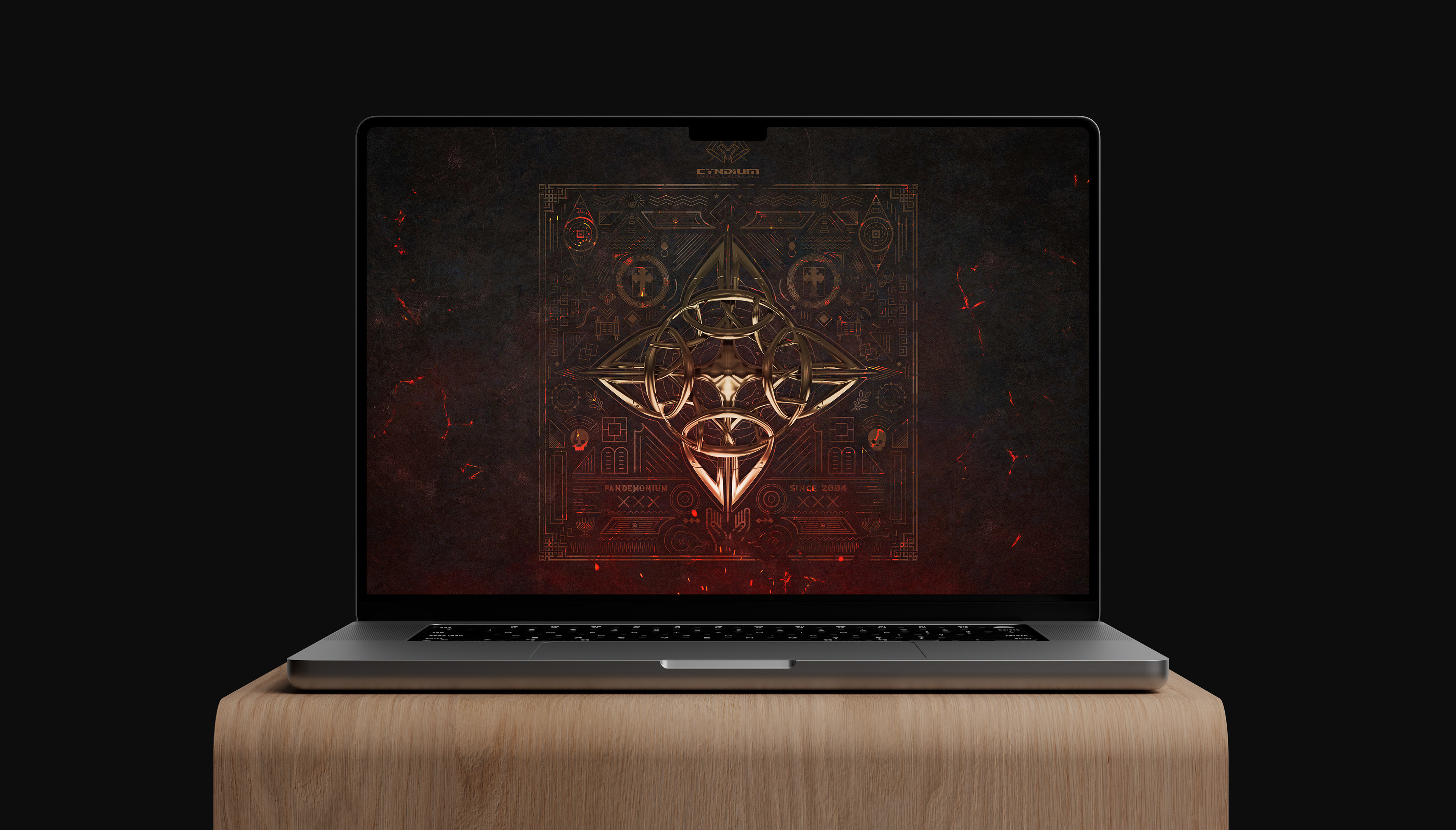 A laptop displaying a wallpaper of complex geometric shapes and symbols on a dark background.