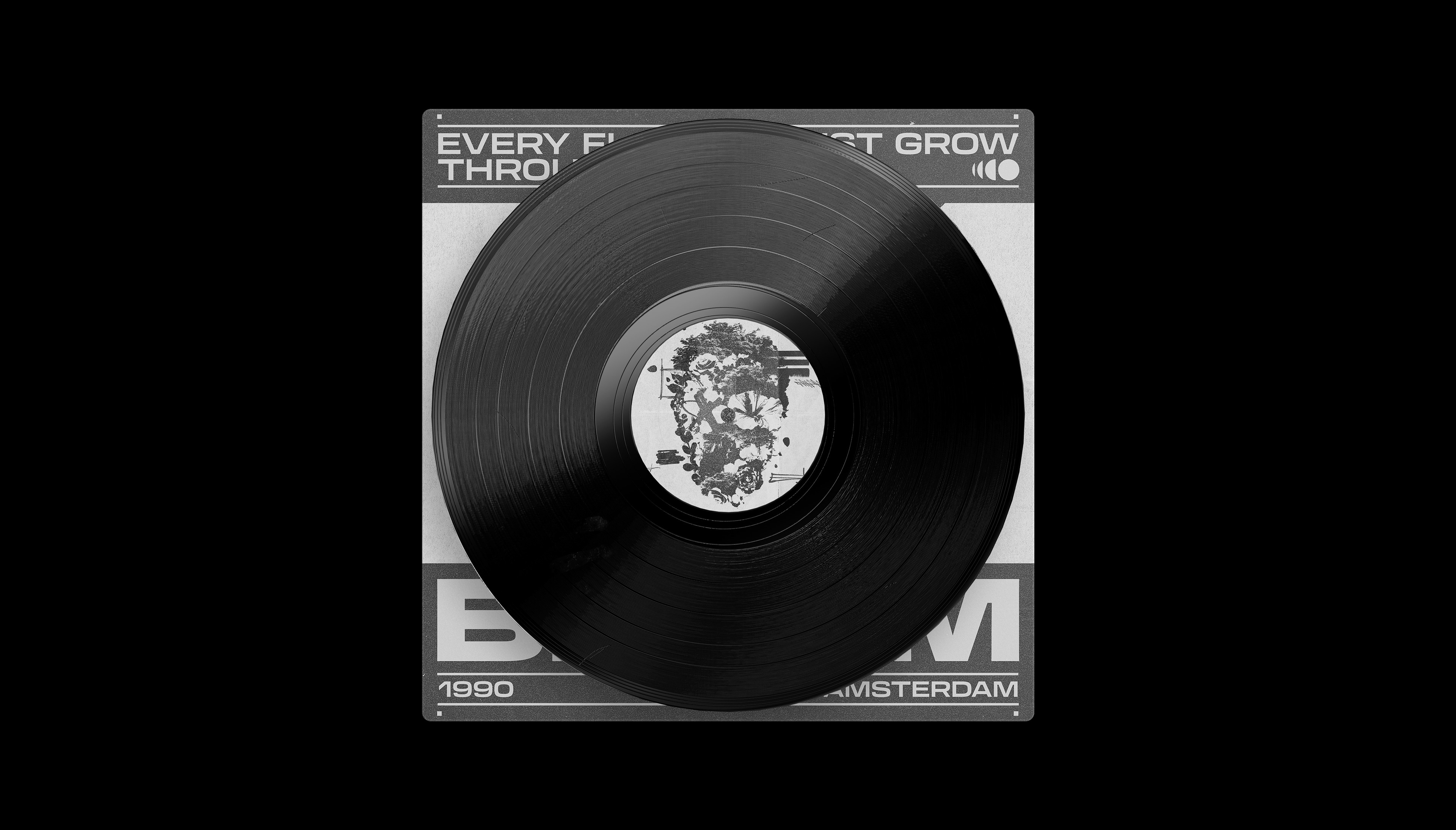 Black-and-white image of a vinyl record with artistic label, resting on its sleeve.