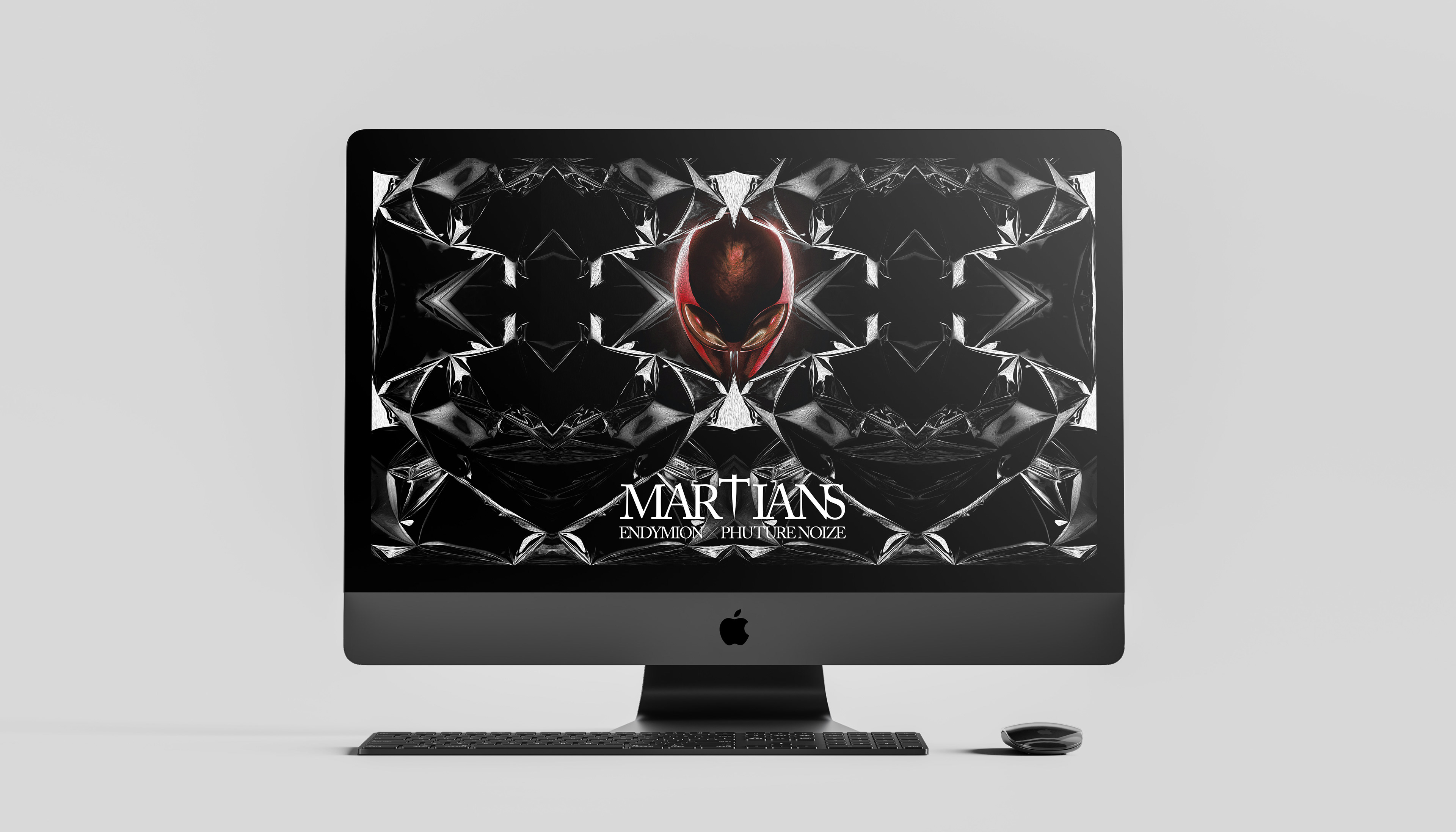 Desktop computer displaying a graphic with a stylized red-eyed mask and the word "MARTIANS" below.