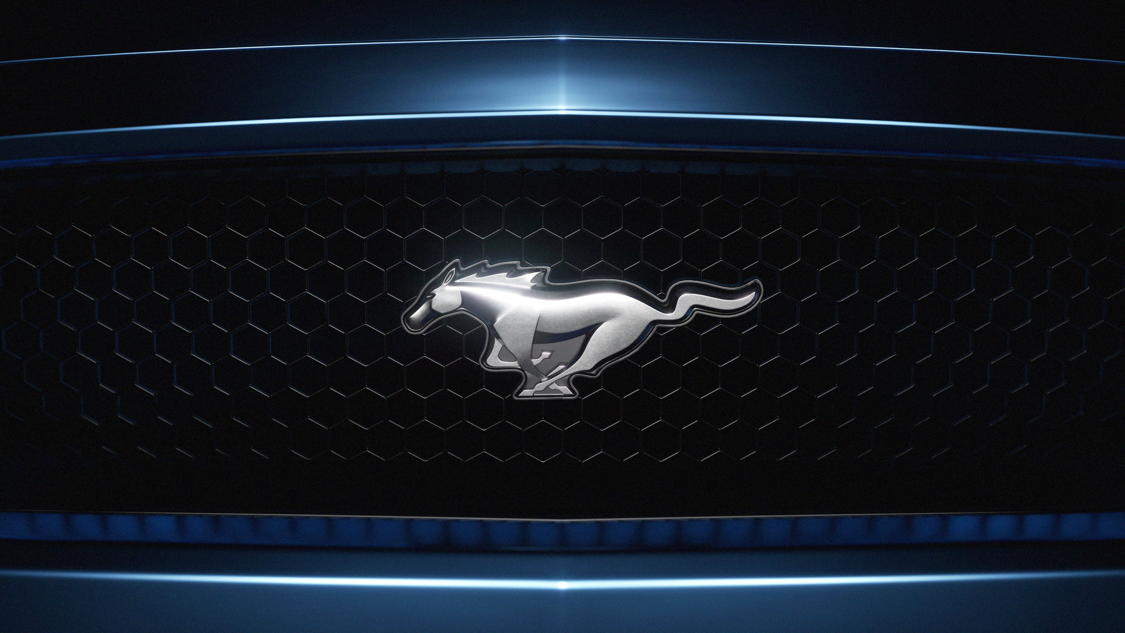 A metallic ford mustang logo centered on a black honeycomb grille with blue lighting accents.