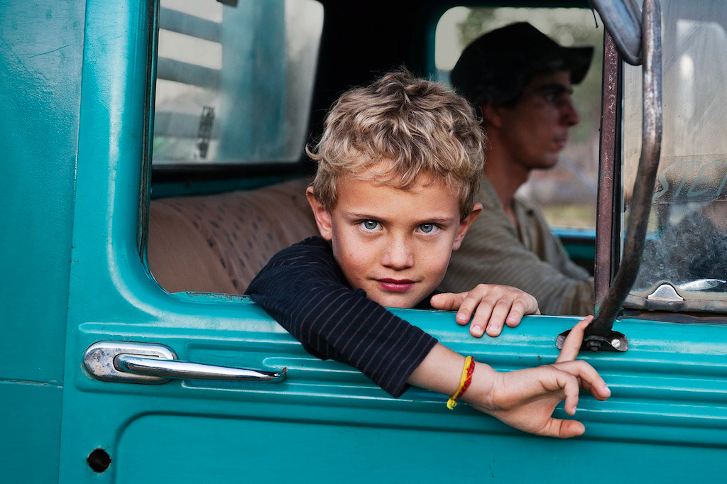 _DSC4677, Lavazza, Lambari, Brazil, 08/2010, BRAZIL-10106NF3. A young boy looks out the window of a truck.final print_MonzaPORTRAITS_APPretouched_Sonny Fabbri 11/2014